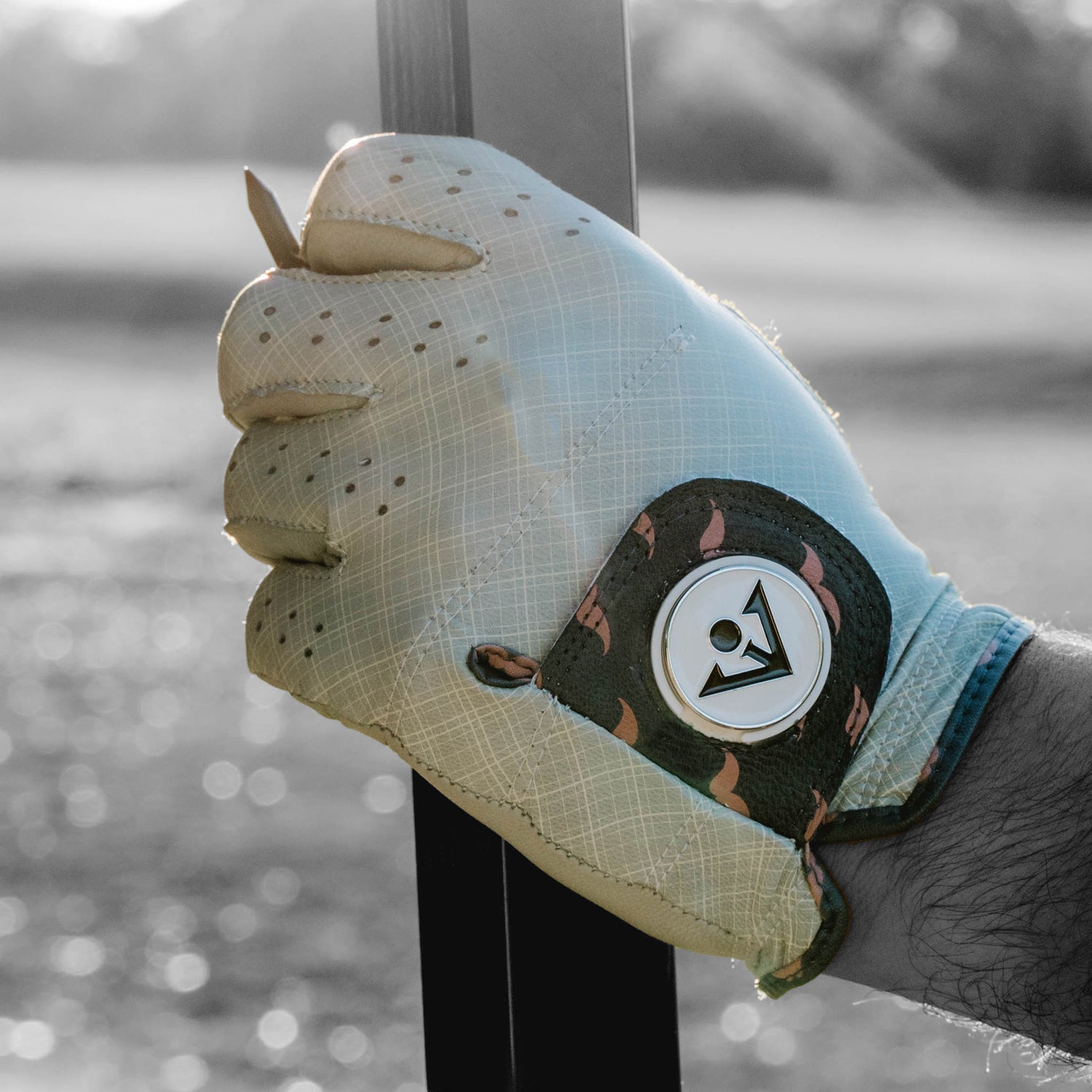 Up close of a cool golf glove in grey plaid pattern and charcoal with mustaches.