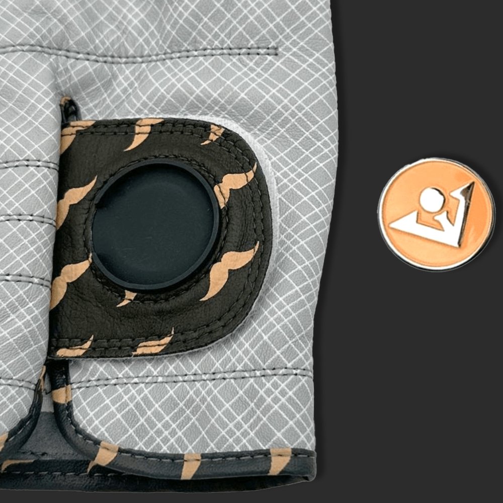 Close-up of the Wooly-Burg Golf Glove with magnetic ball marker and the ball marker out of the magnetic cavity in a charcoal background.
