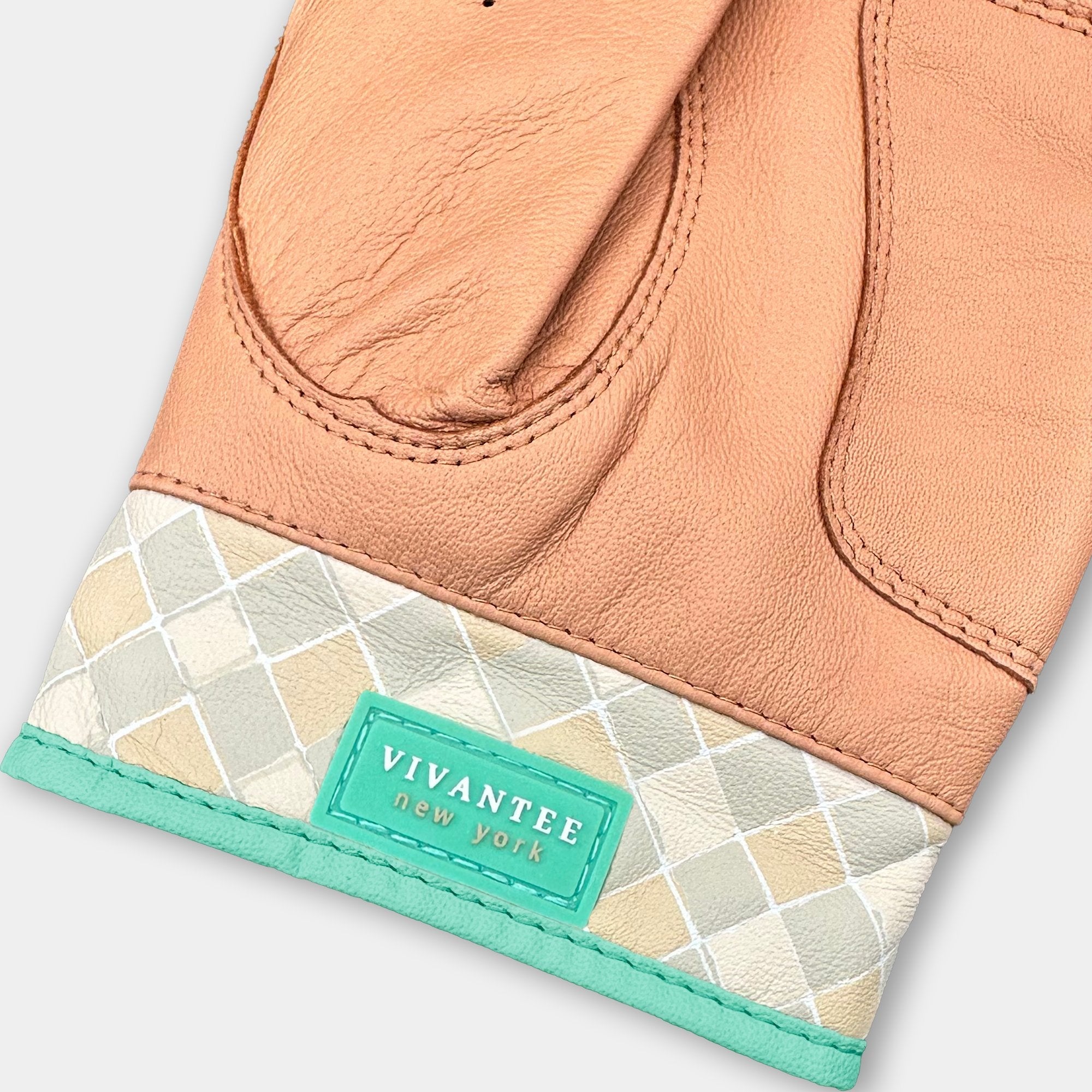Close-up of a brown leather golf glove with a geometric patterned cuff and Vivantee New York label.