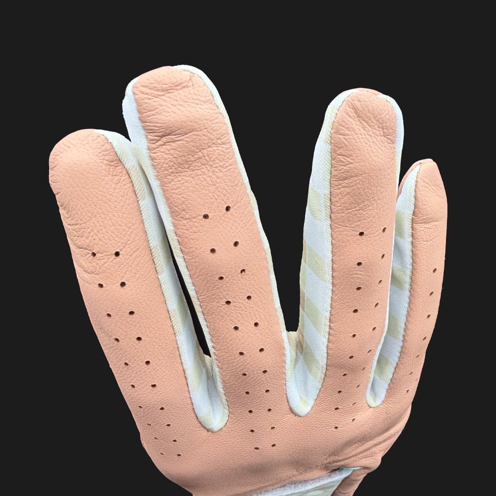 Close-up of a beige golf glove with lycra between the fingers.