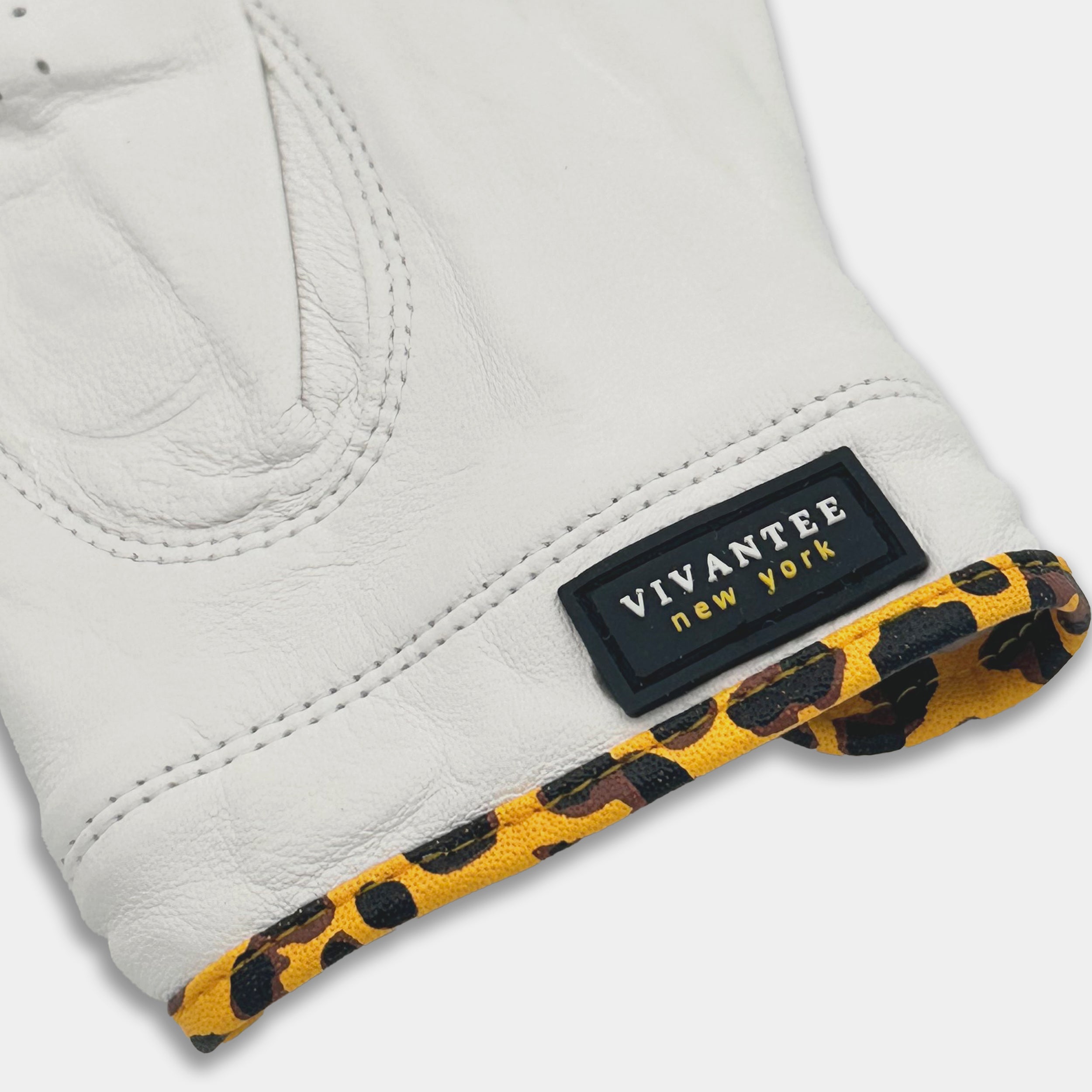 White glove with leopard print cuff and Vivantee New York label on a white background