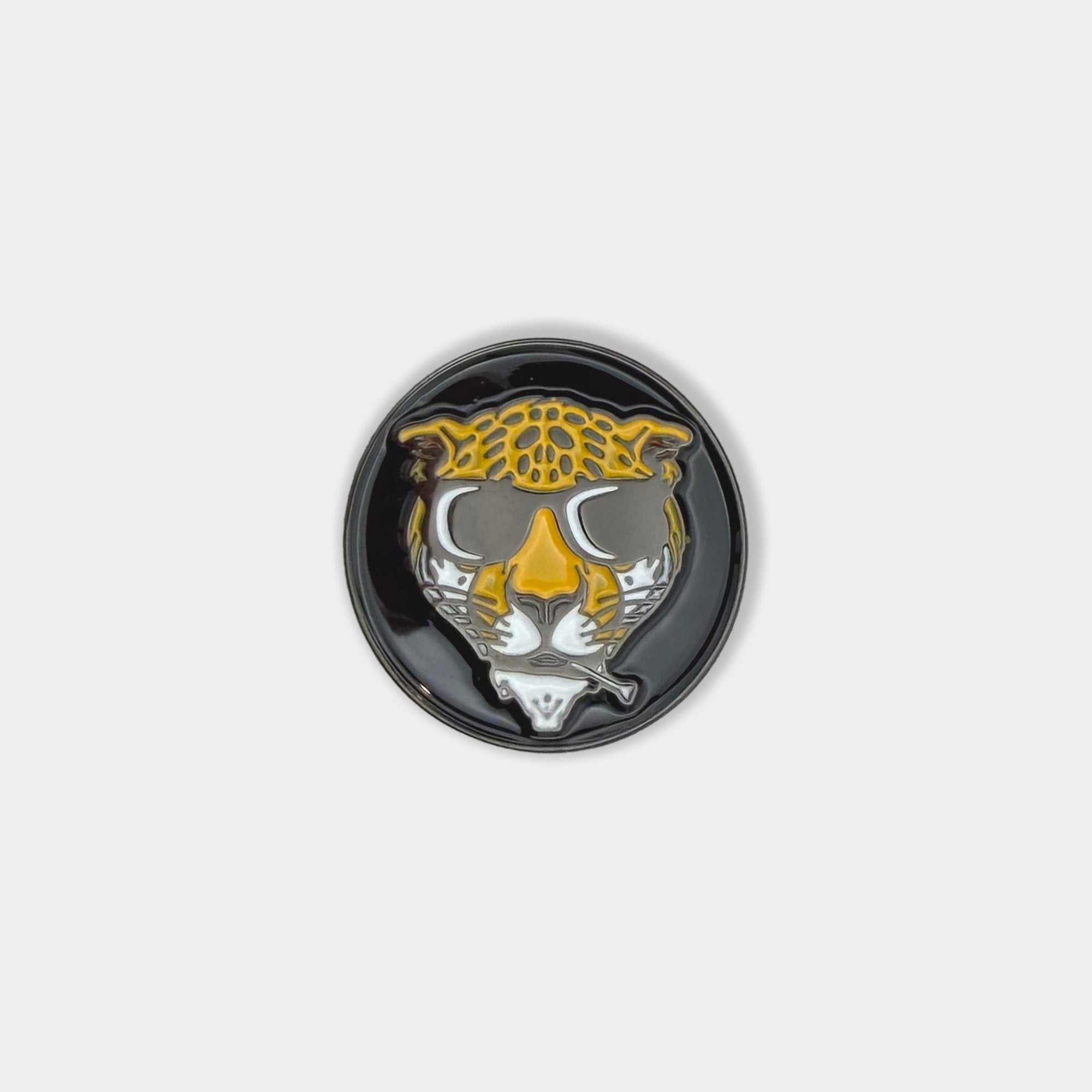 Image of a magnetic golf ball marker close up with a cheetah in sunglasses and a tee in it's mouth by VivanTee Golf.