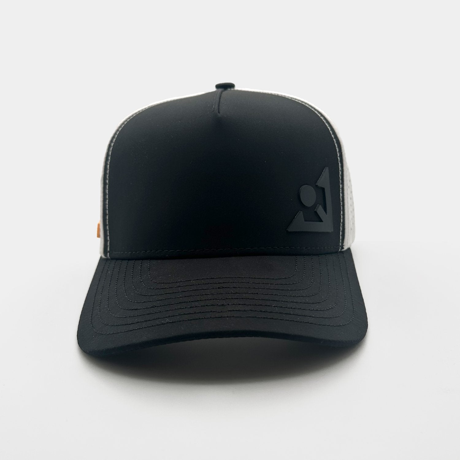 Athletic trucker-style cap with a sleek black front and brim, contrasted by white ventilated mesh on the back. The front has an embossed black emblem, and the interior showcases branded taping arranged in a cross pattern.