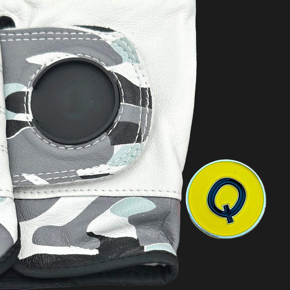 Camouflage-patterned golf glove with a black magnetic cavity on a black background.