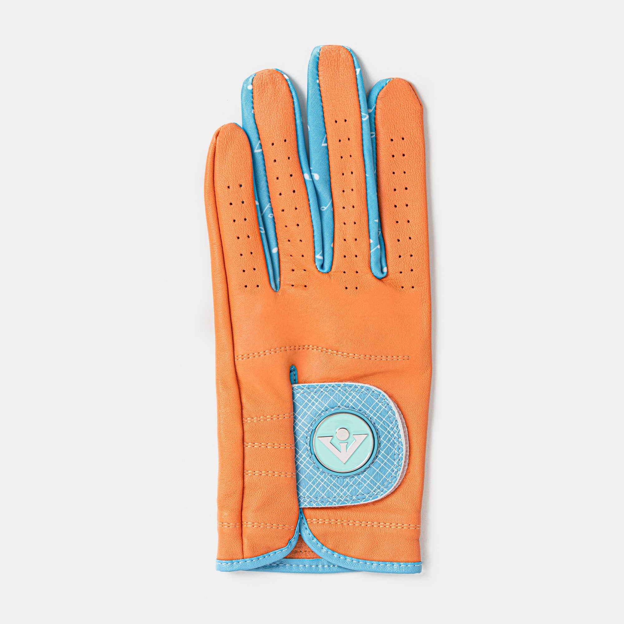 Women's orange and blue golf glove with magnetic marker laid out with a white background.