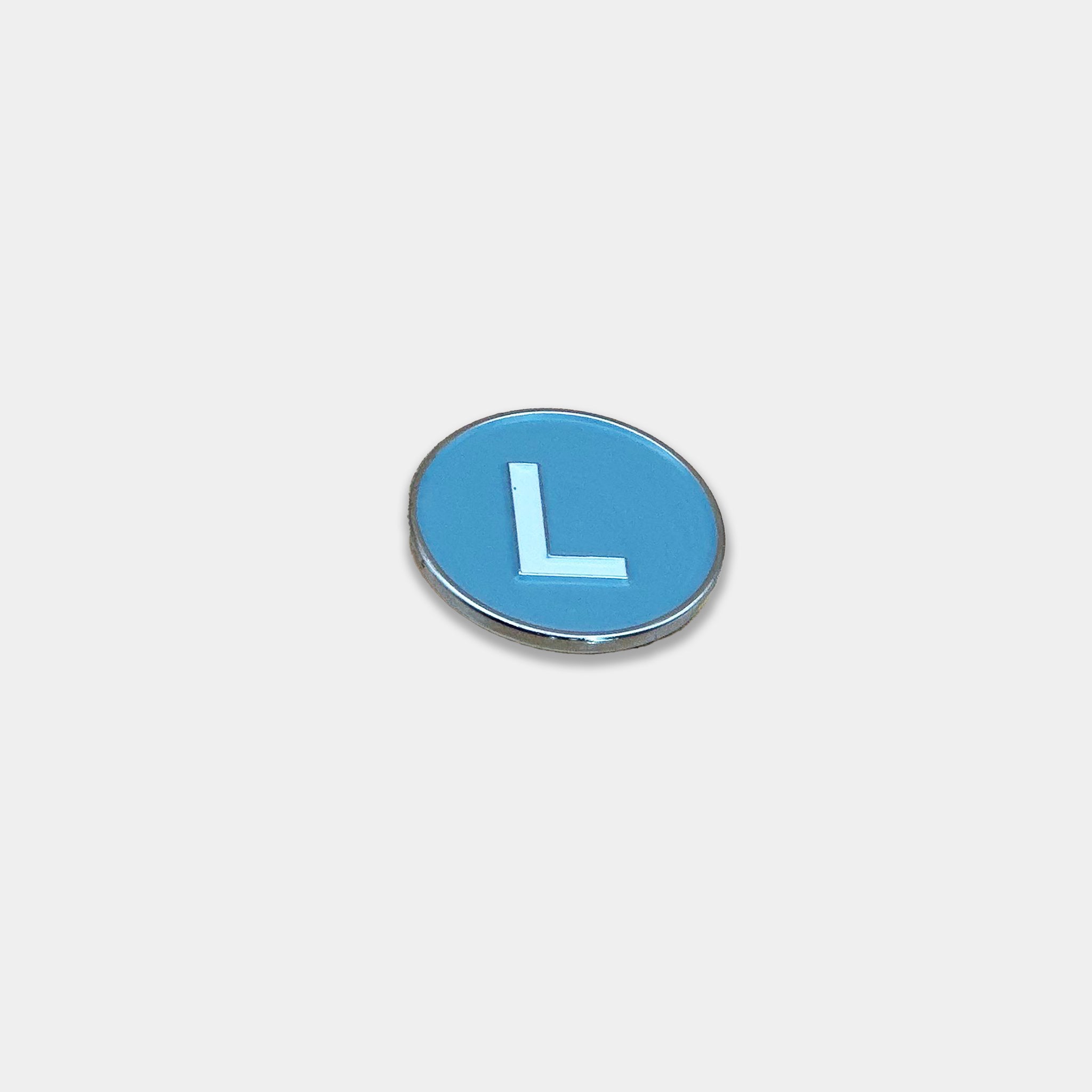 L Train magnetic golf ball marker at a front angle view.