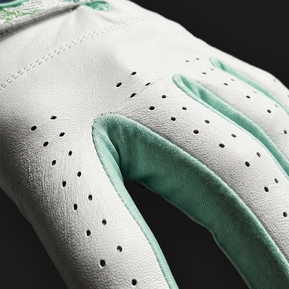 Close up of lycra between fingers glove glove with a black background.