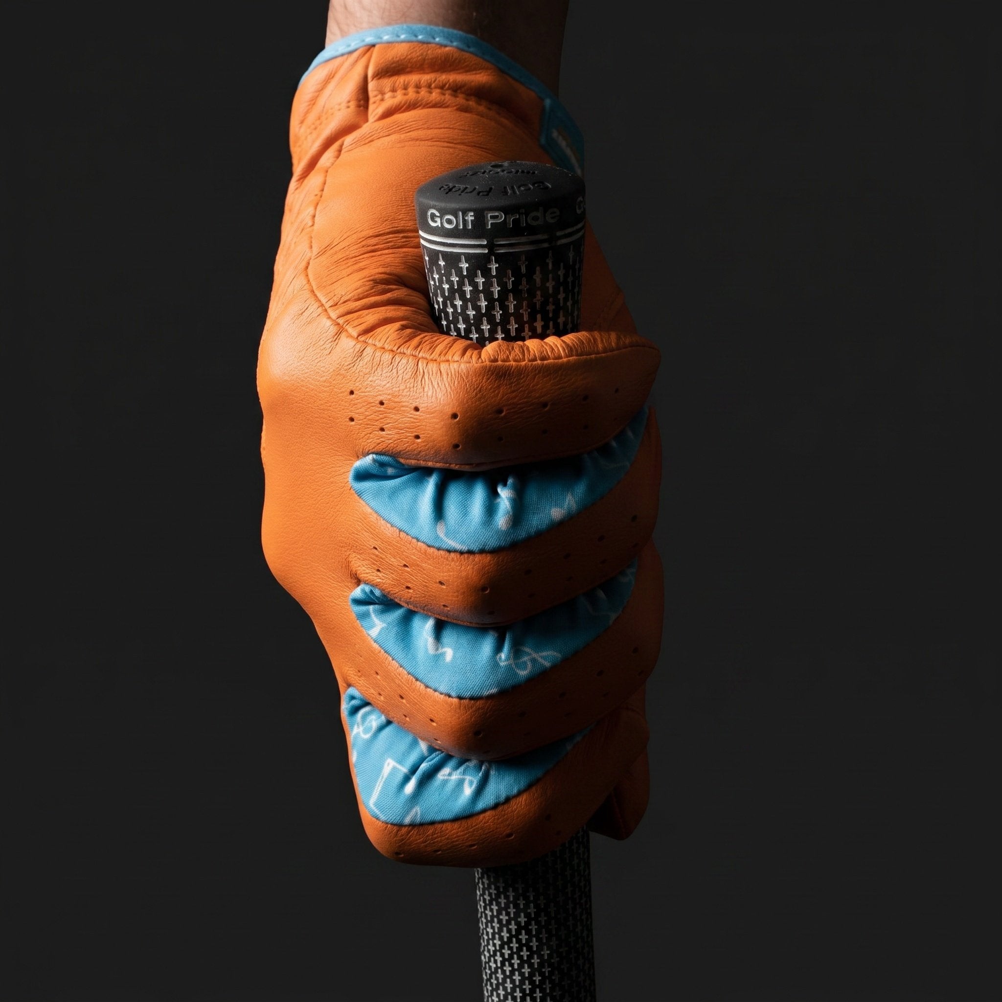 Orange golf glove with blue lycra holding a golf club by VivanTee Golf on a black background
