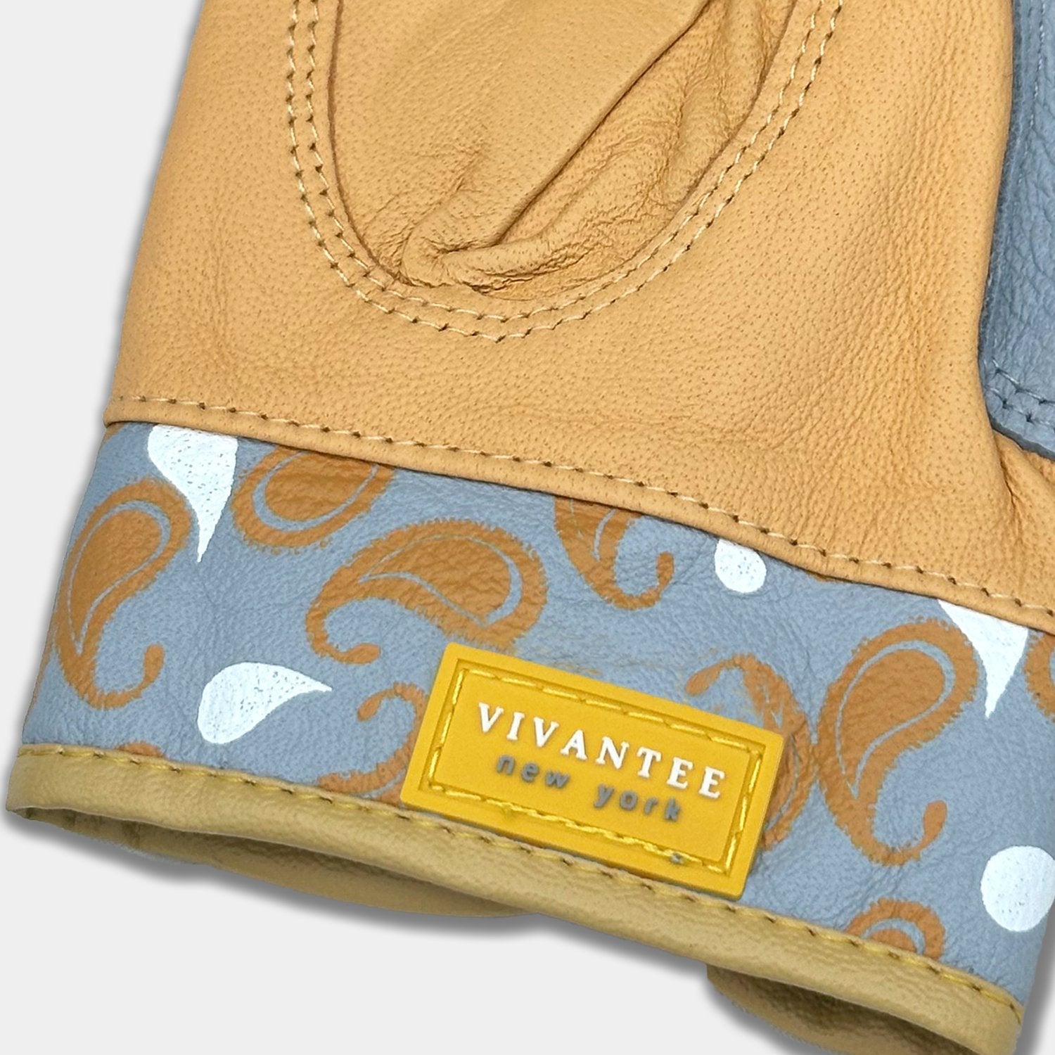 Close-up of a leather golf glove with paisley patterned lining and Vivantee label.