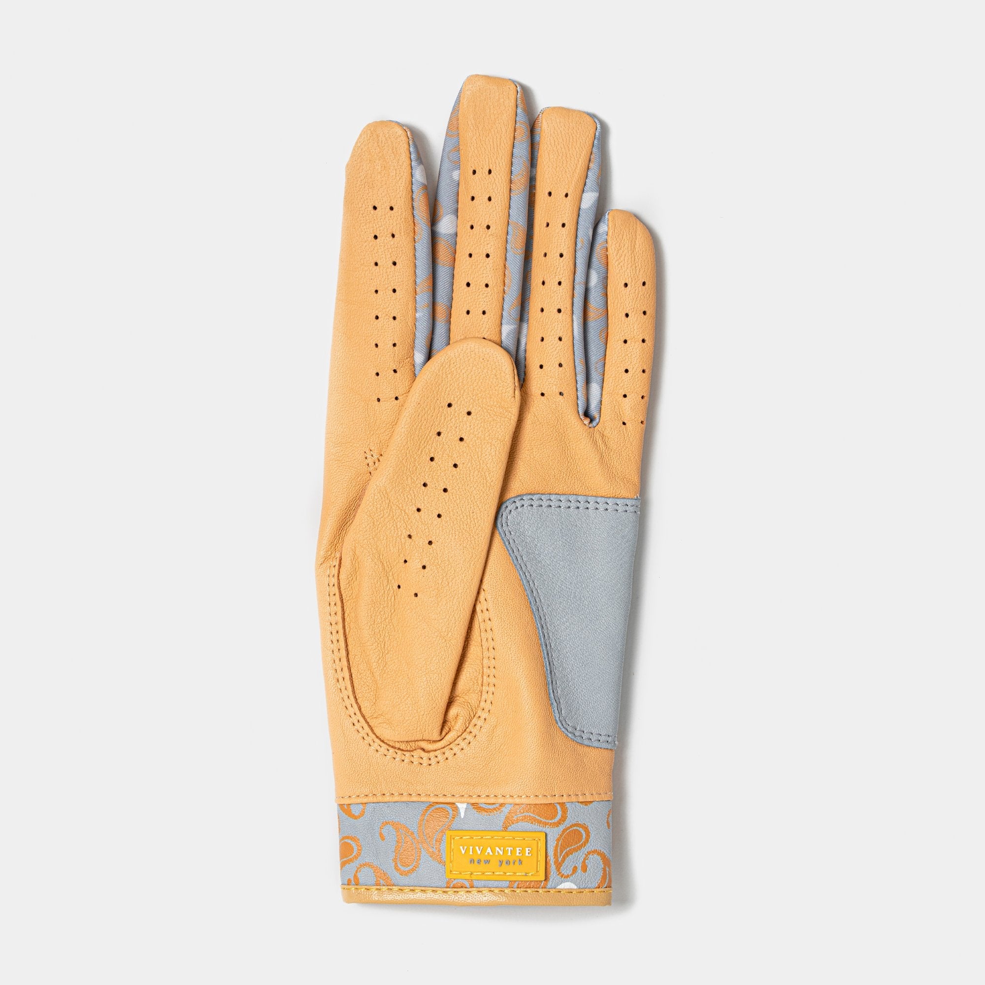 Bottom of a women's gold and grey golf glove with paisley pattern on a white background.