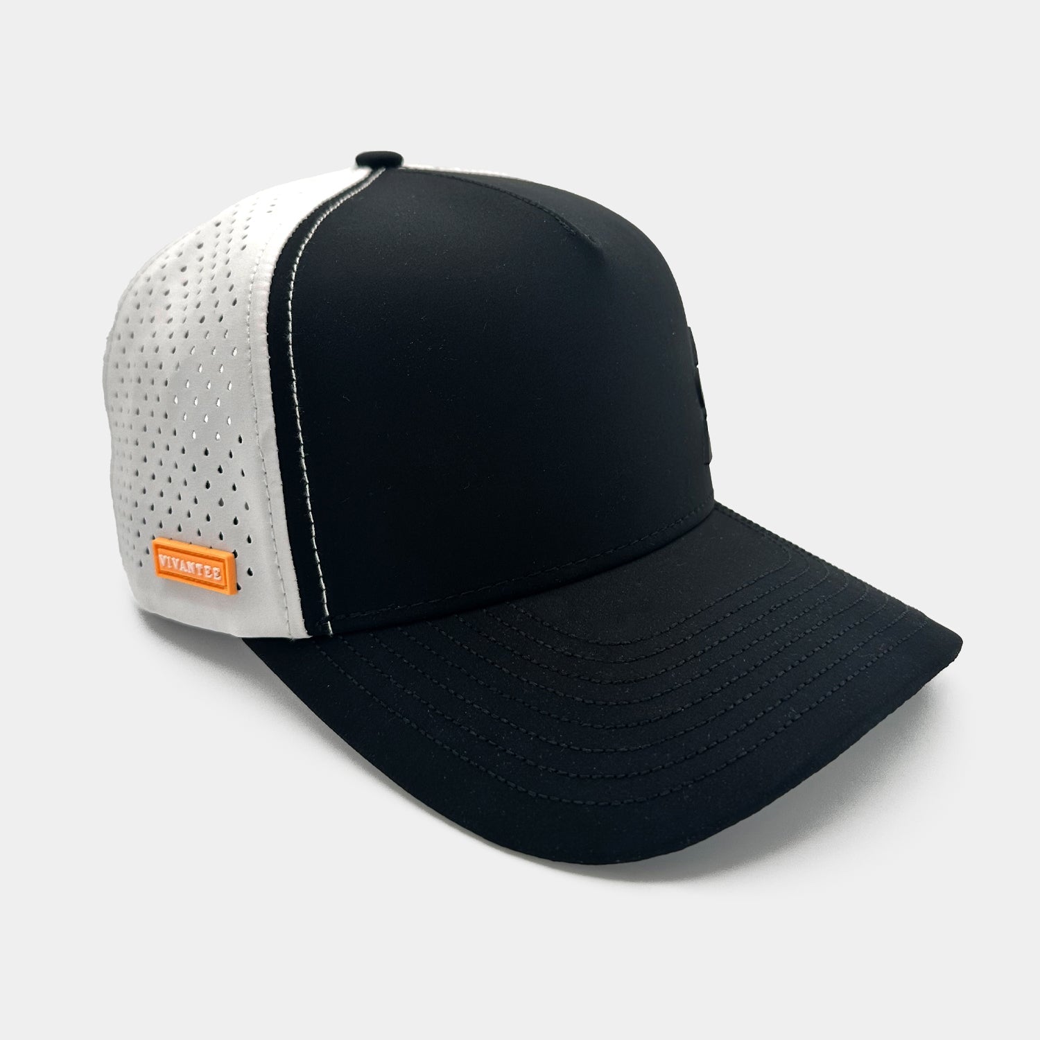 Two-tone golf cap with a black structured front and curved bill, and white mesh sides with small perforations. A subtle black emblem decorates the front, and an orange tag reading “VIVANTEE” is sewn on the side. The interior view displays branded cross straps.