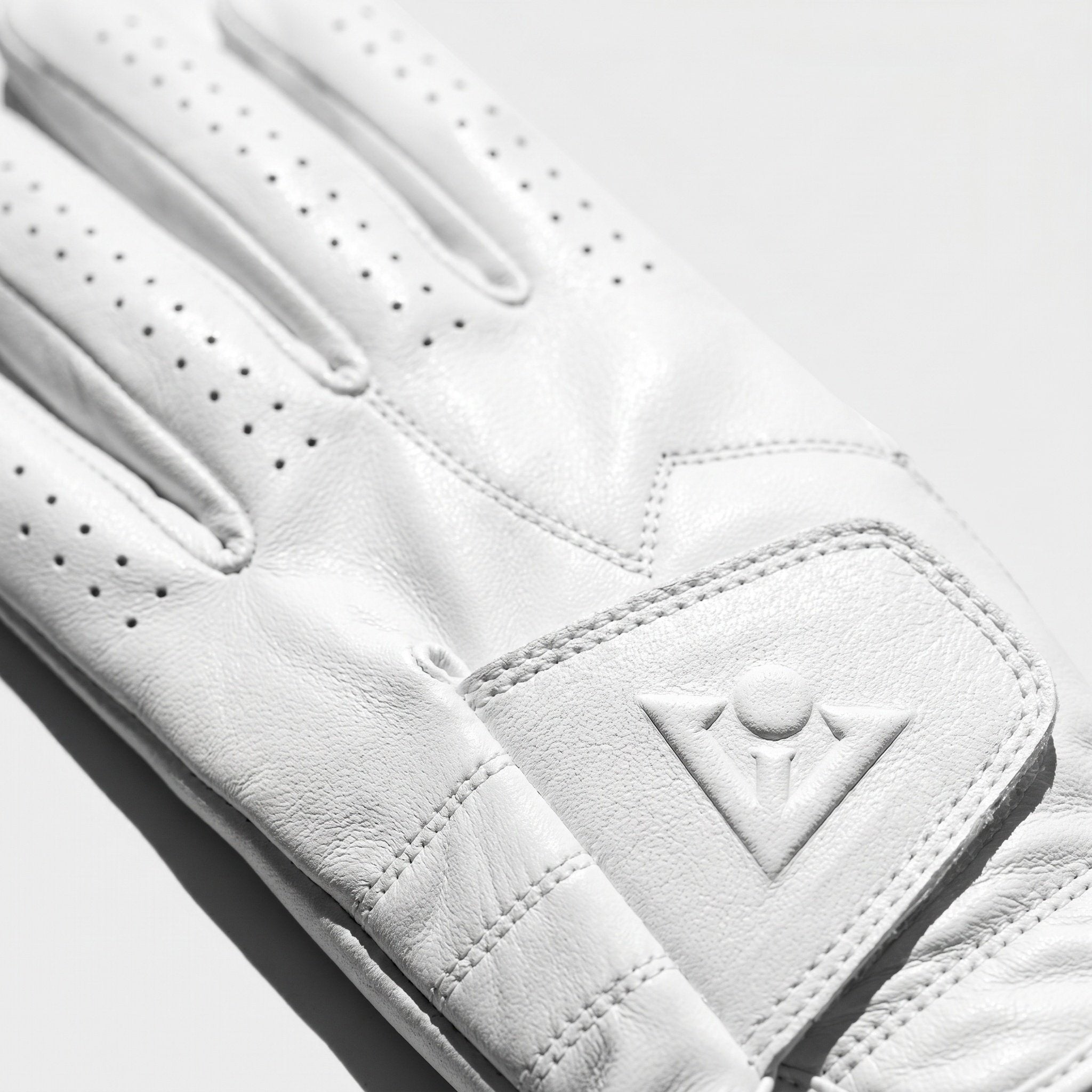 Pure white golf glove by VivanTee golf with a light grey background.