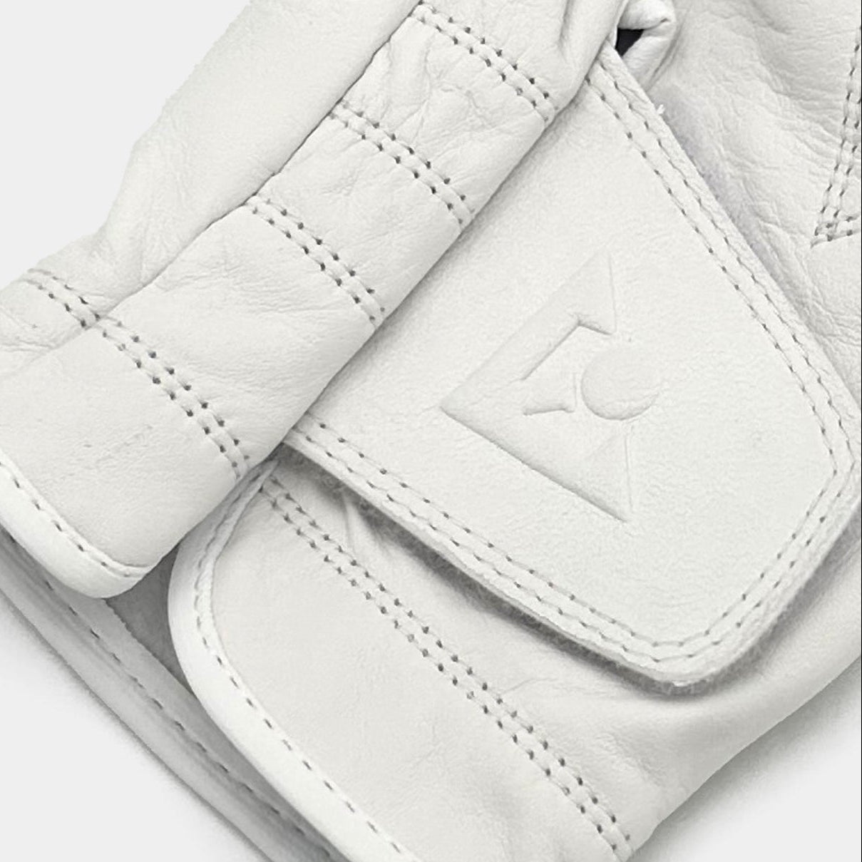 Close-up of a white golf glove with a VivanTee logo on a light gray background