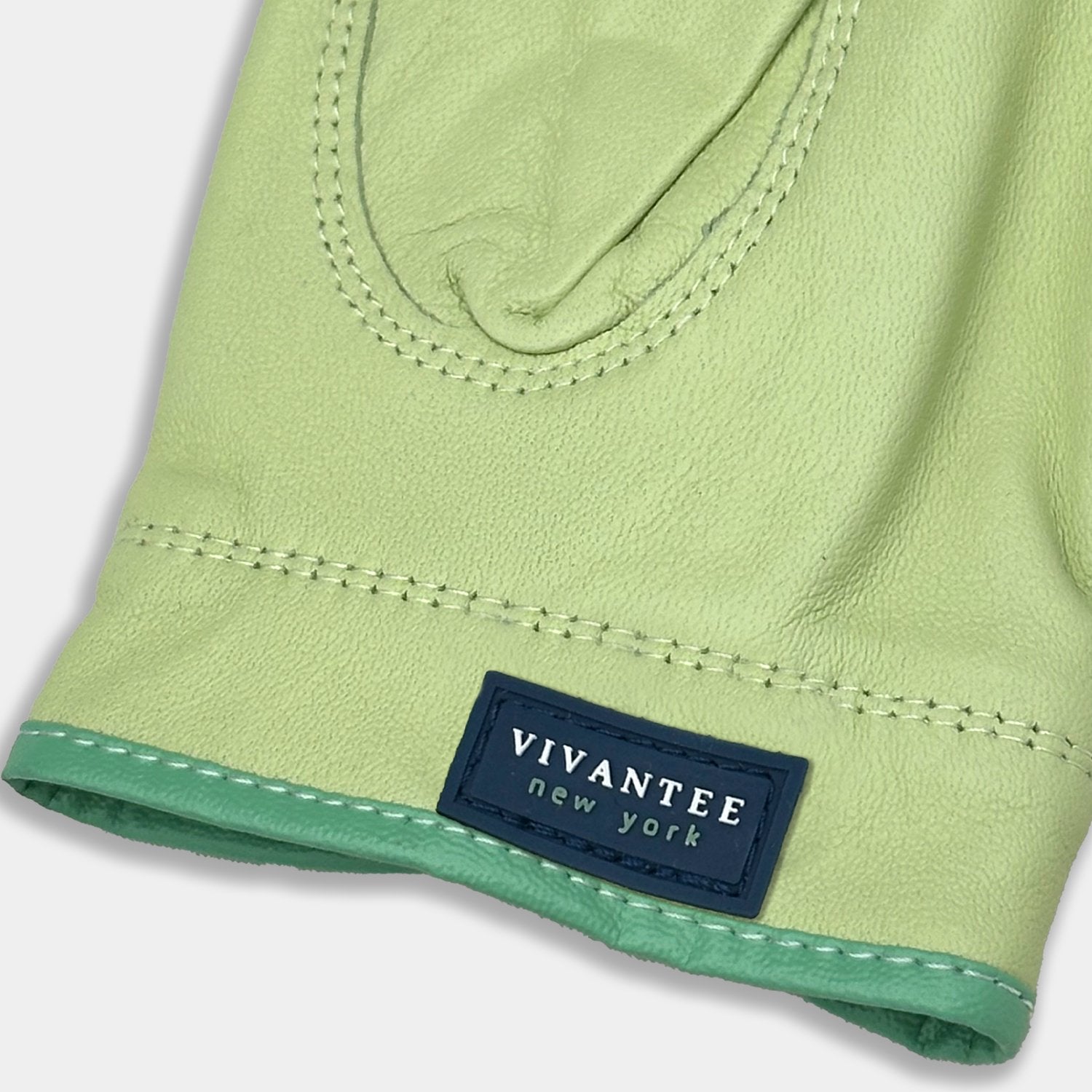 Green leather golf glove with a blue "VivanTee" label on a light gray background.