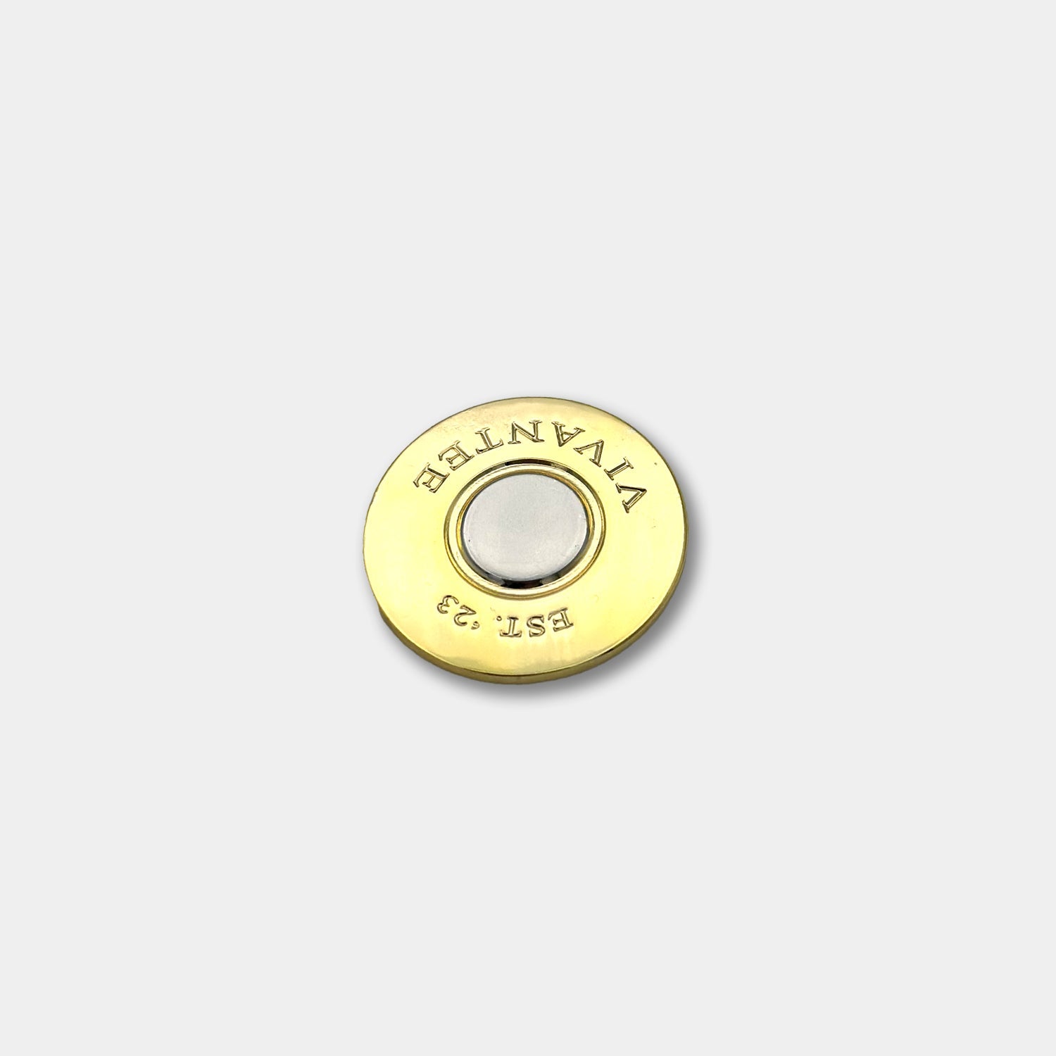 Gold shotgun shell-style golf ball marker with engraved "VIVANTEE" and "EST. '23" text, featuring a magnetic center.