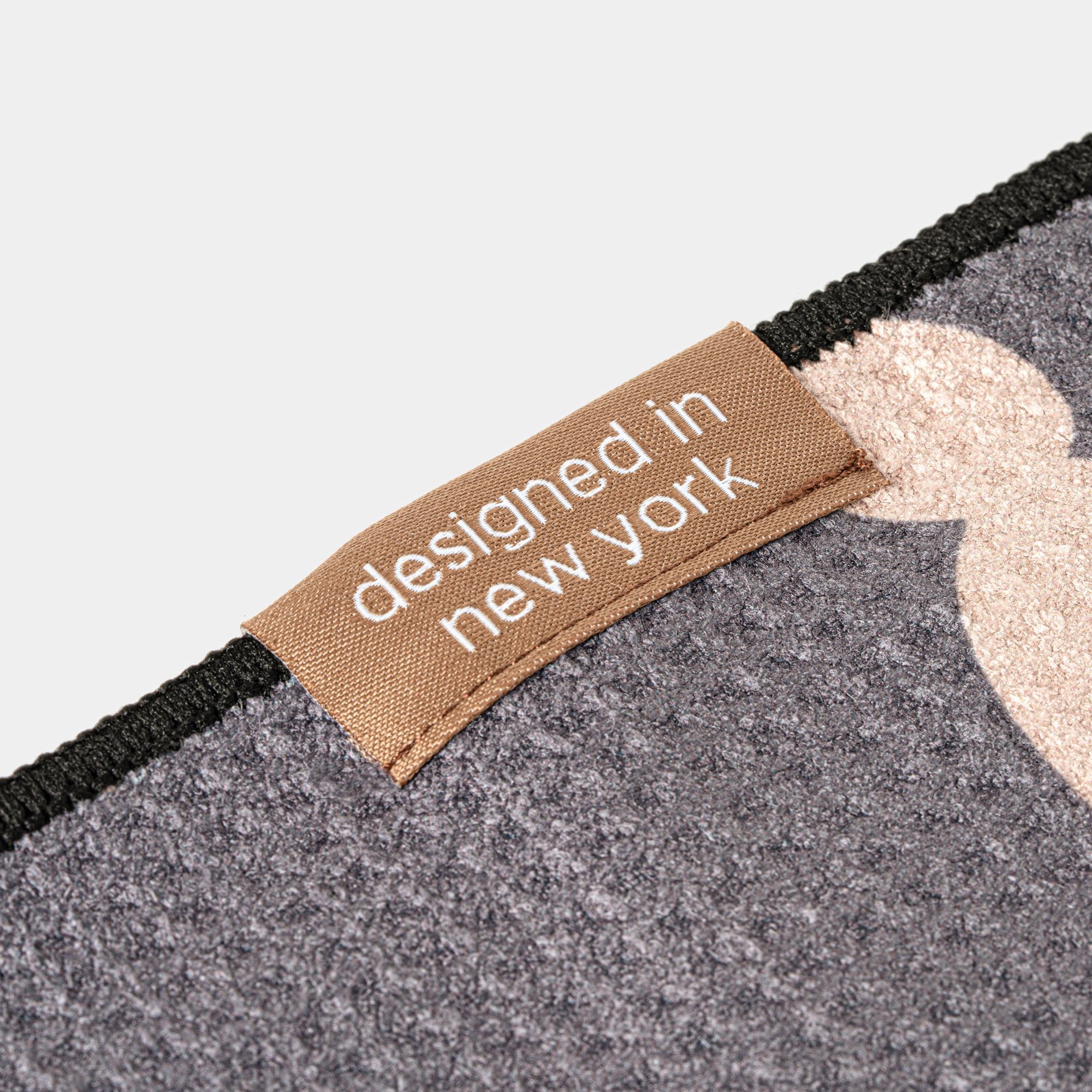 Golf towel with mustaches close up with 'designed in New York' label on a neutral background
