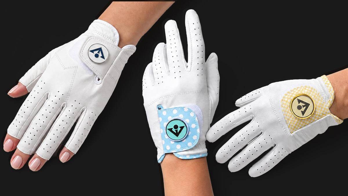 Three VivanTee women's golf gloves on a black background: the Fingerless Pure White with minimalist ball marker, the SoHo Sky with powder blue polka dot tab and teal ball marker, and the SoHo Butter with butter yellow checkered tab and gold ball marker. All crafted in white AAA Cabretta leather.