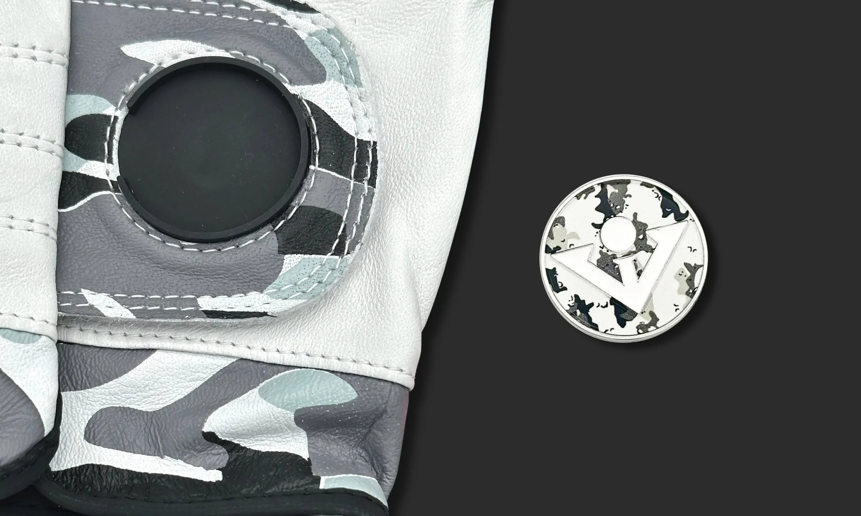 Camo golf glove with magnetic ball marker laying next to the glove in camo as well.  