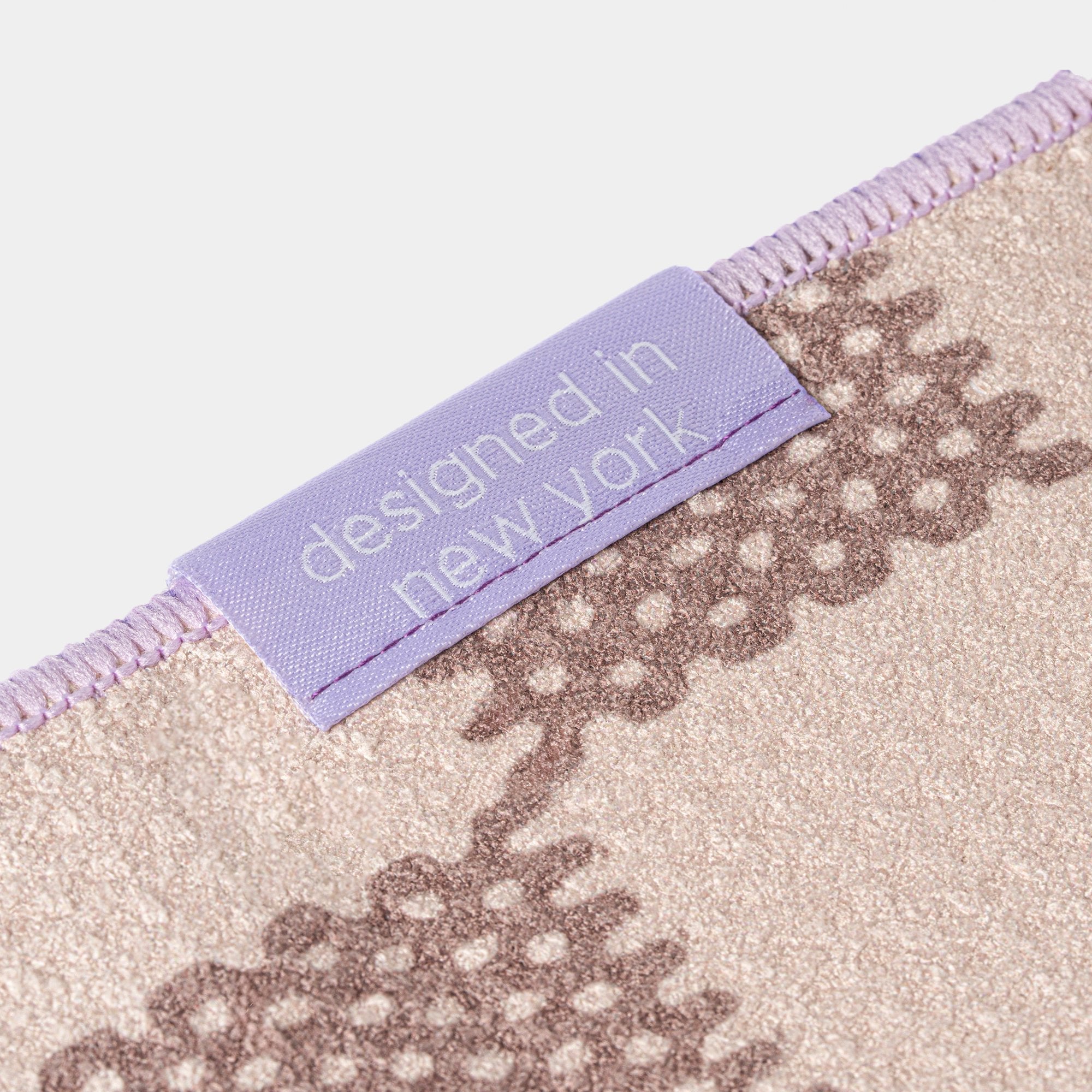 Golf Towel with a label reading 'designed in New York' on a white background