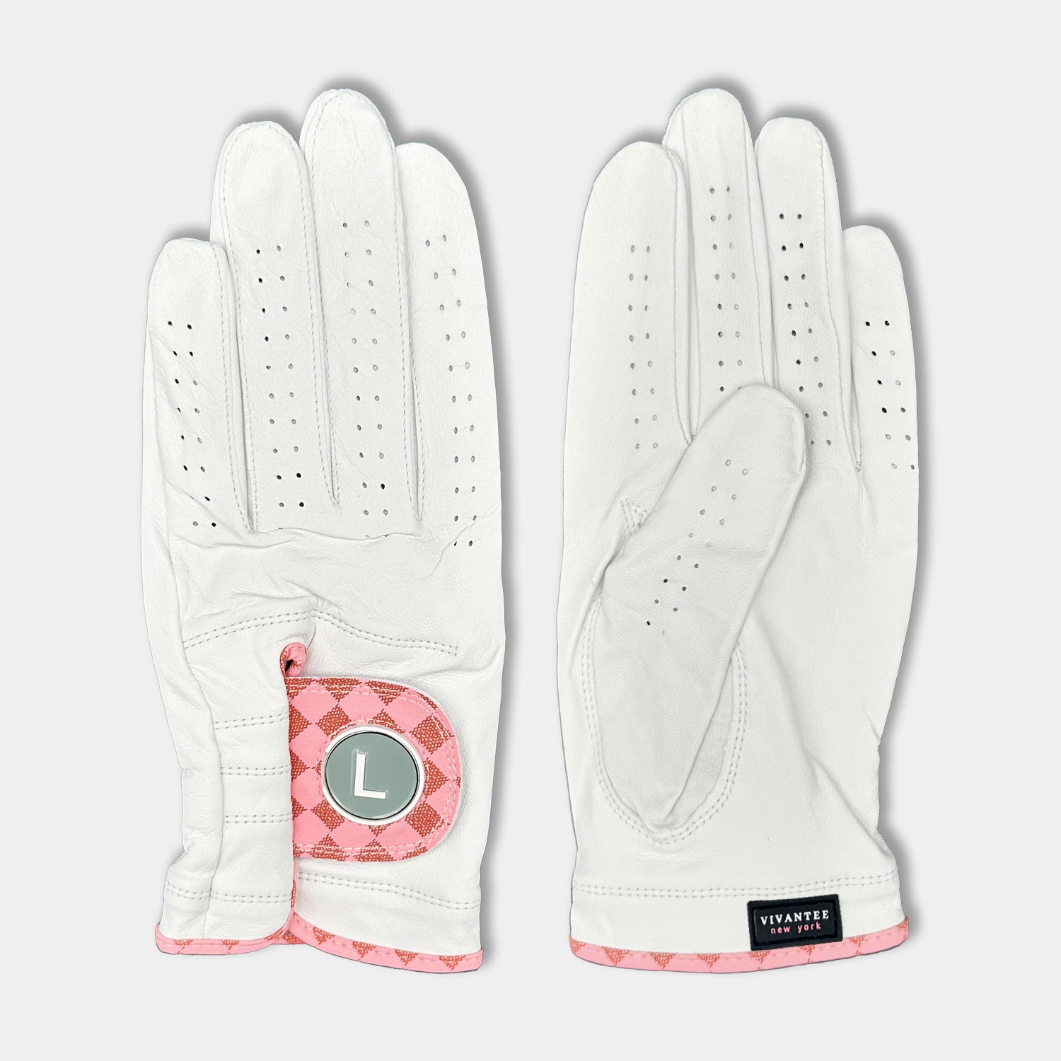 White and blush pink designer golf glove with a black backdrop to show case the unique colors and patterns.