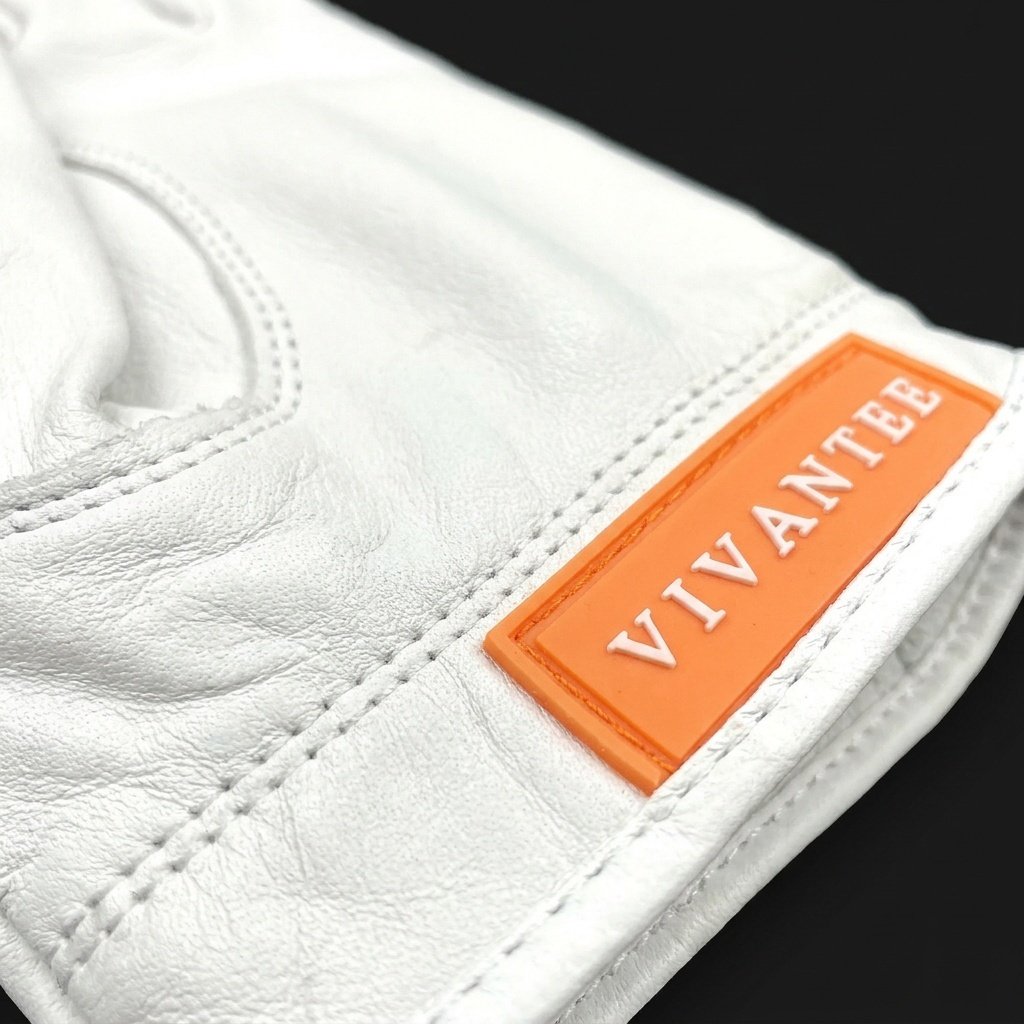 White golf glove with an orange 'VIVANTEE' label on a black background