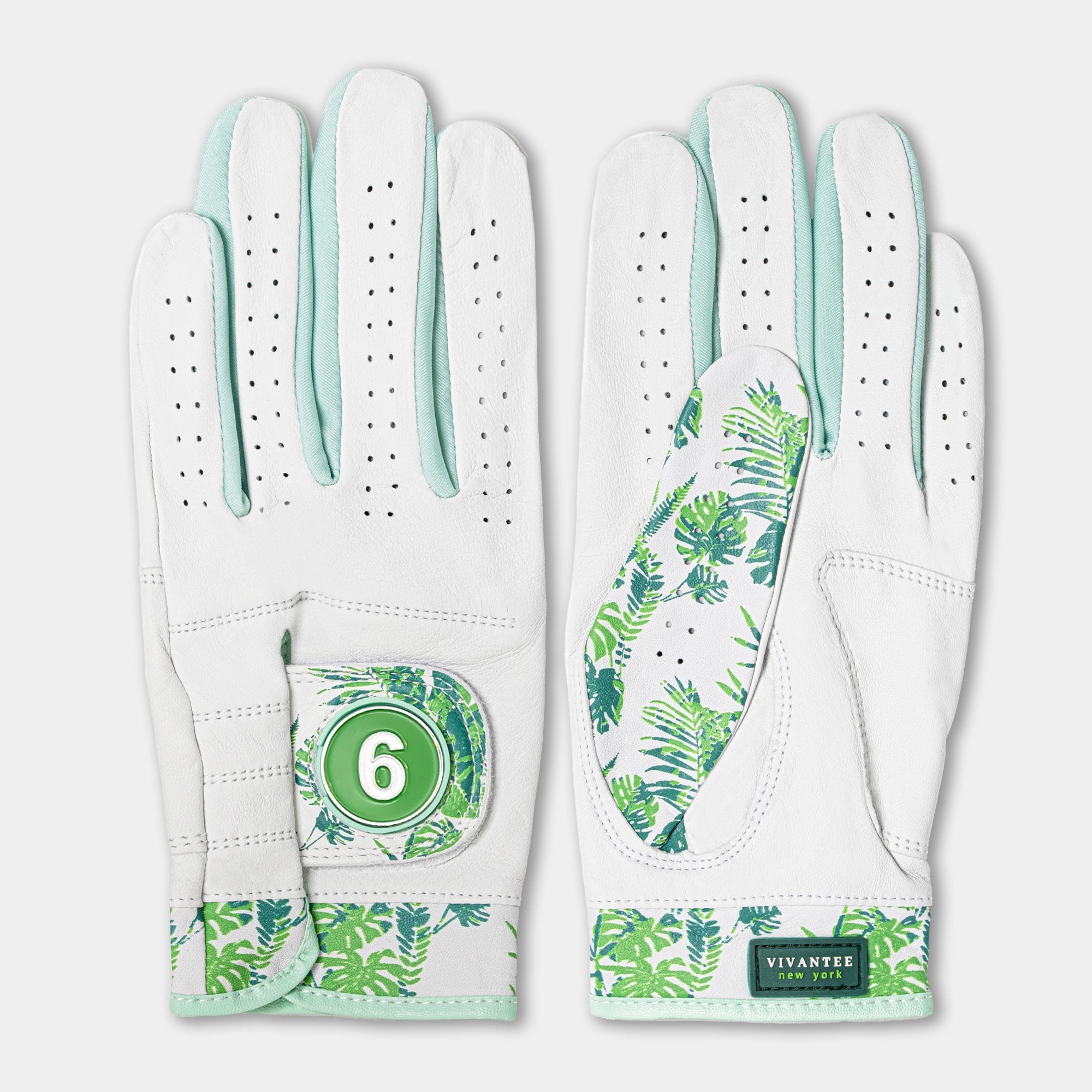 White golf glove with green leaf pattern and number 6 on a light gray background