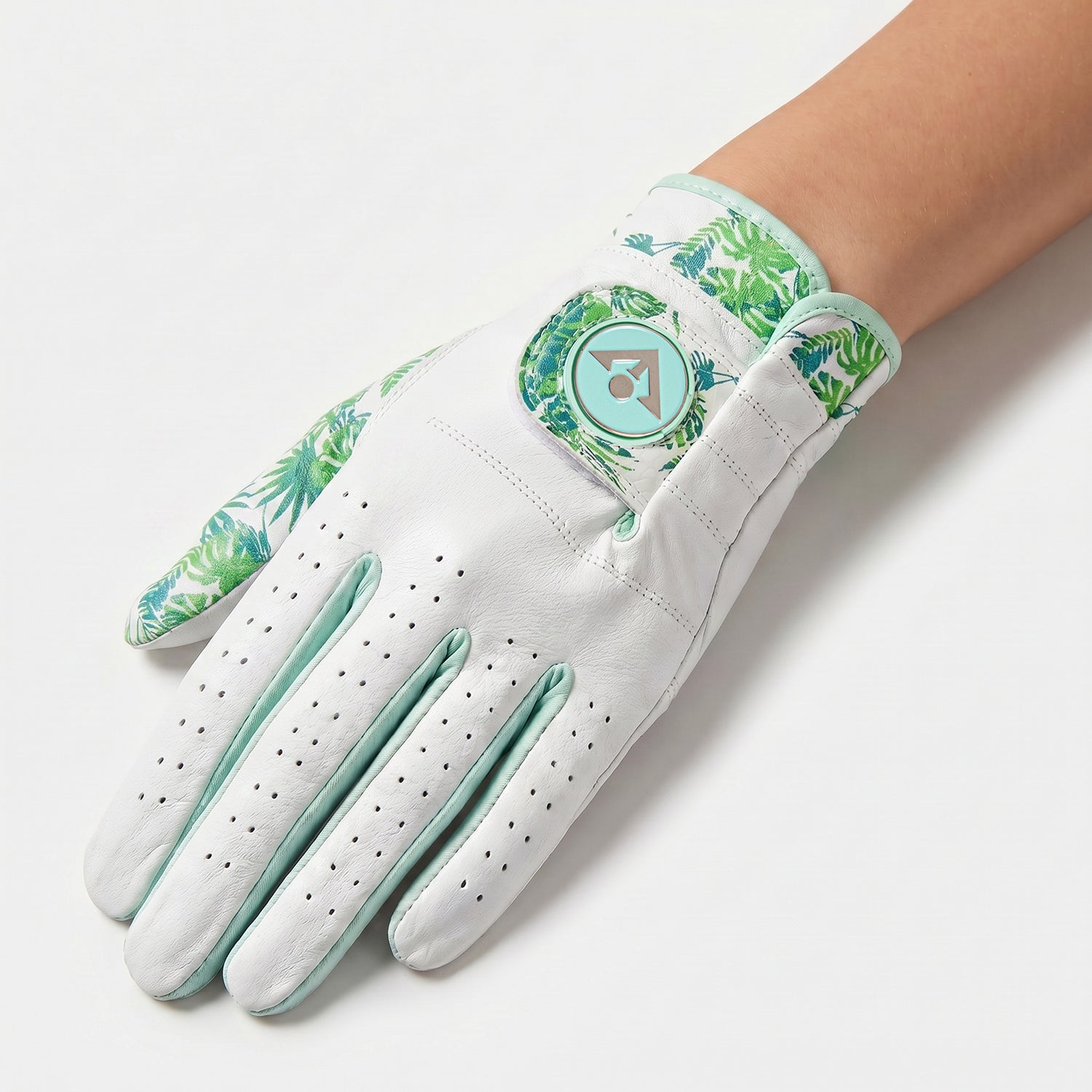 White Women's palm golf glove with green floral pattern on a white background