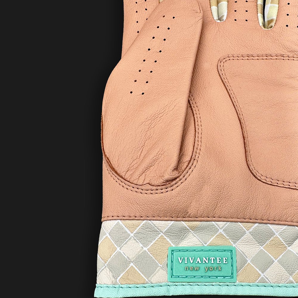 Tan leather golf glove with checkered pattern and a tag stating "VivanTee New York" with a dark background.