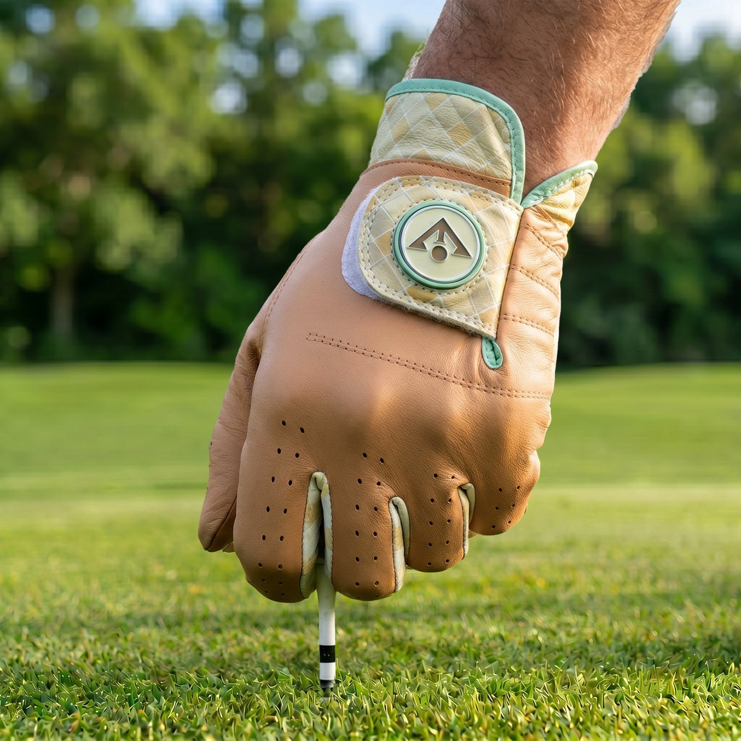 Brown Golf glove on a hand holding a golf club on a grassy background