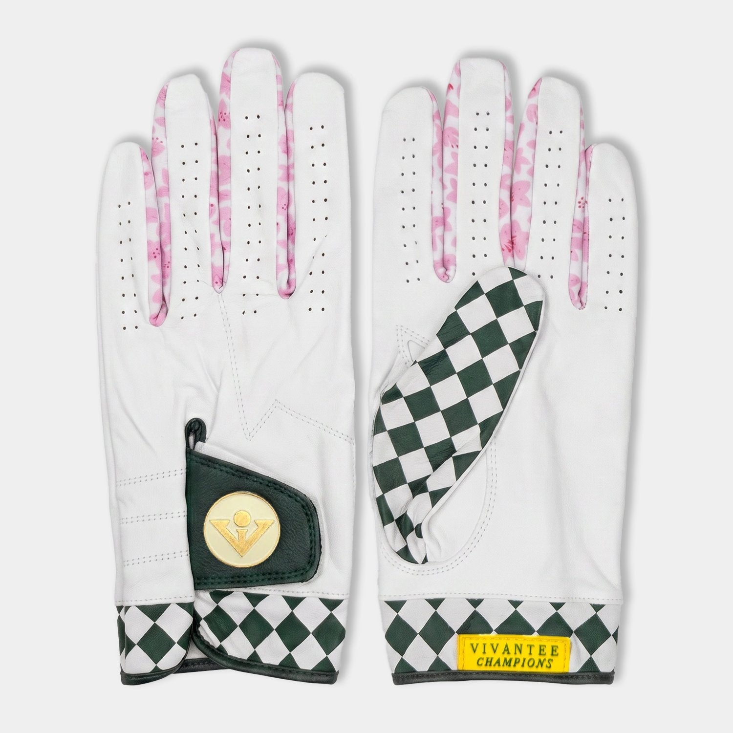 White golf gloves with green and pink checkered pattern on a white background