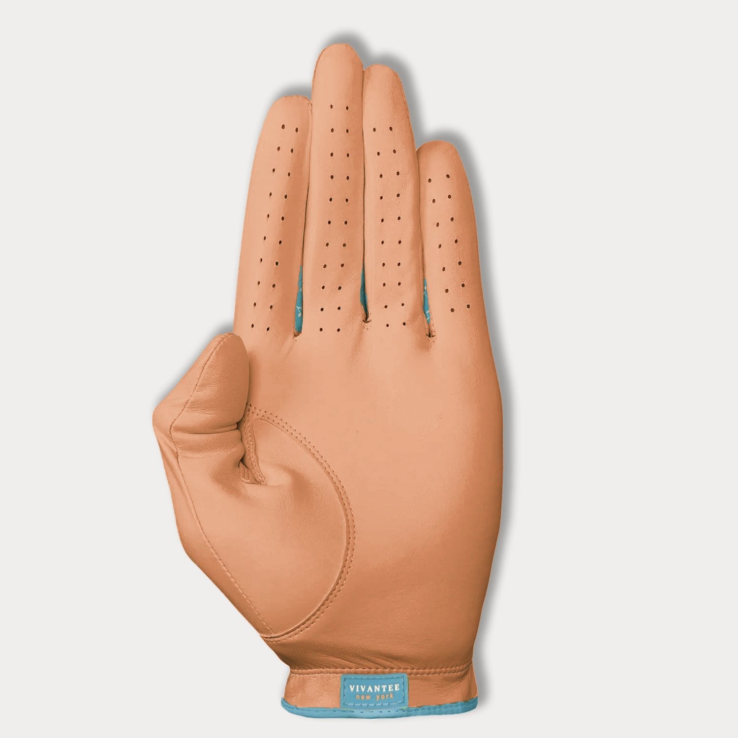 Apricot colored women's leather glove with a visible brand label on a light gray background.