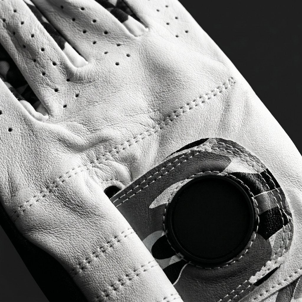 Close up of camo golf glove with premium cabretta leather in a dark background.