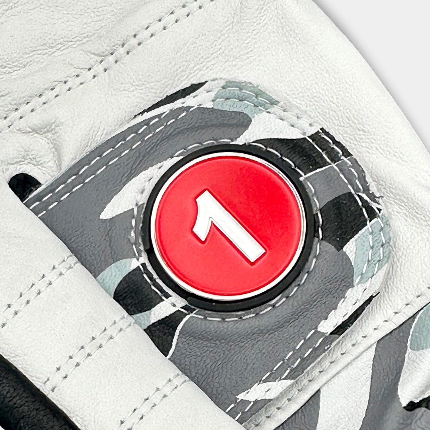 Close-up of a VivanTee Cabretta leather golf glove in gray camouflage with black palm reinforcement, designed for durability, grip, and style on the course.