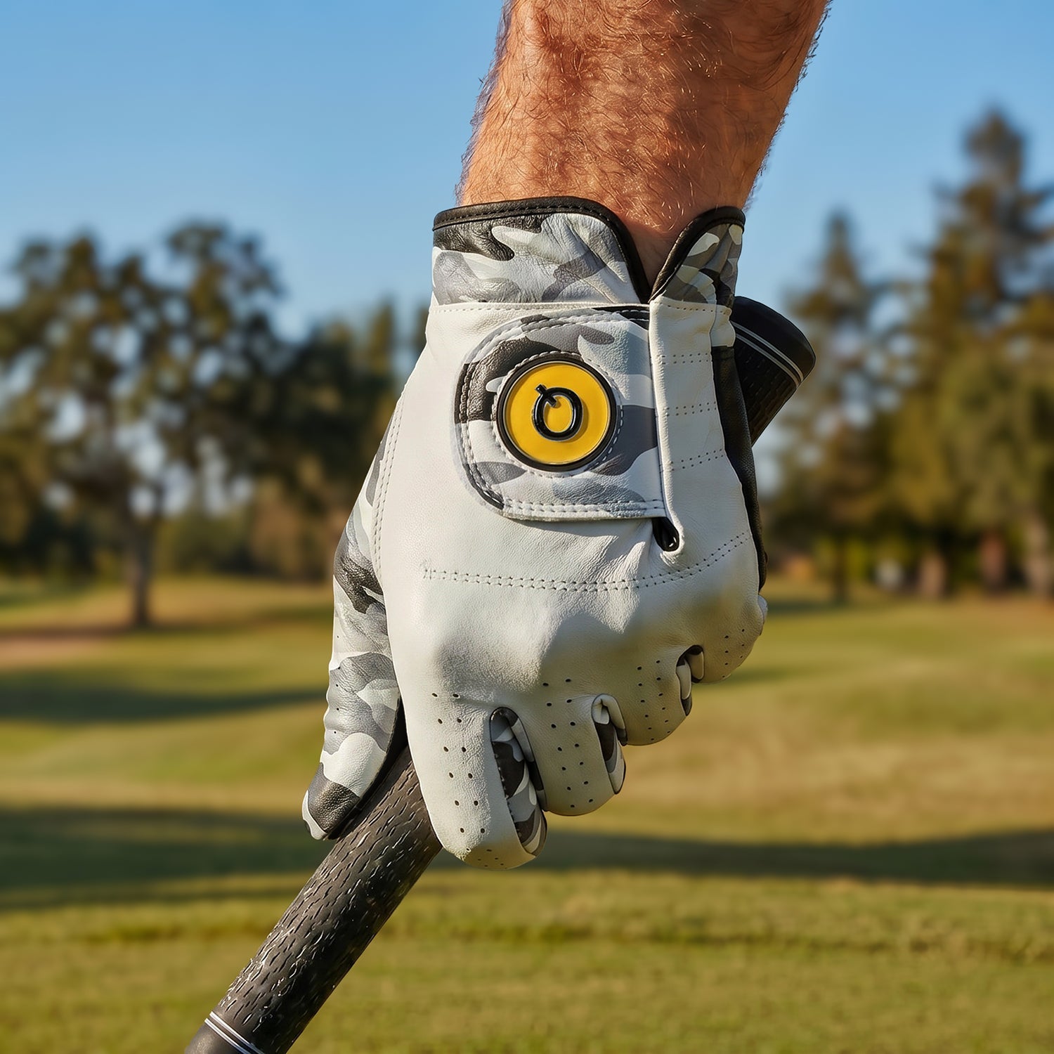 Camo Golf glove on a golf club with a blurred golf course background