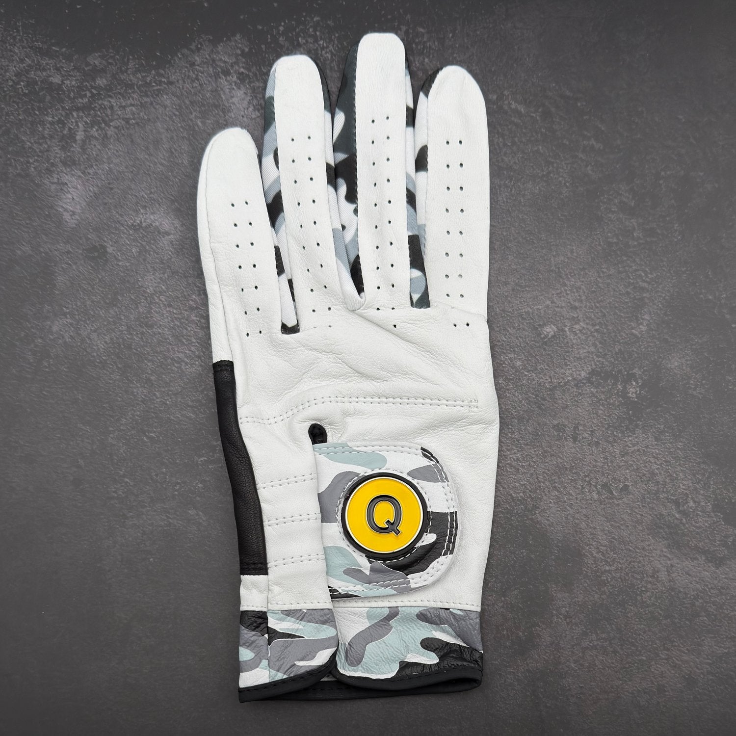 White golf glove with camouflage pattern on a dark gray background