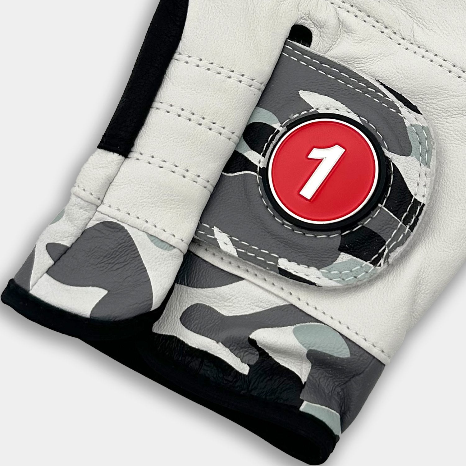Close-up of a VivanTee Cabretta leather golf glove in gray camouflage with black palm reinforcement, designed for durability, grip, and style on the course.