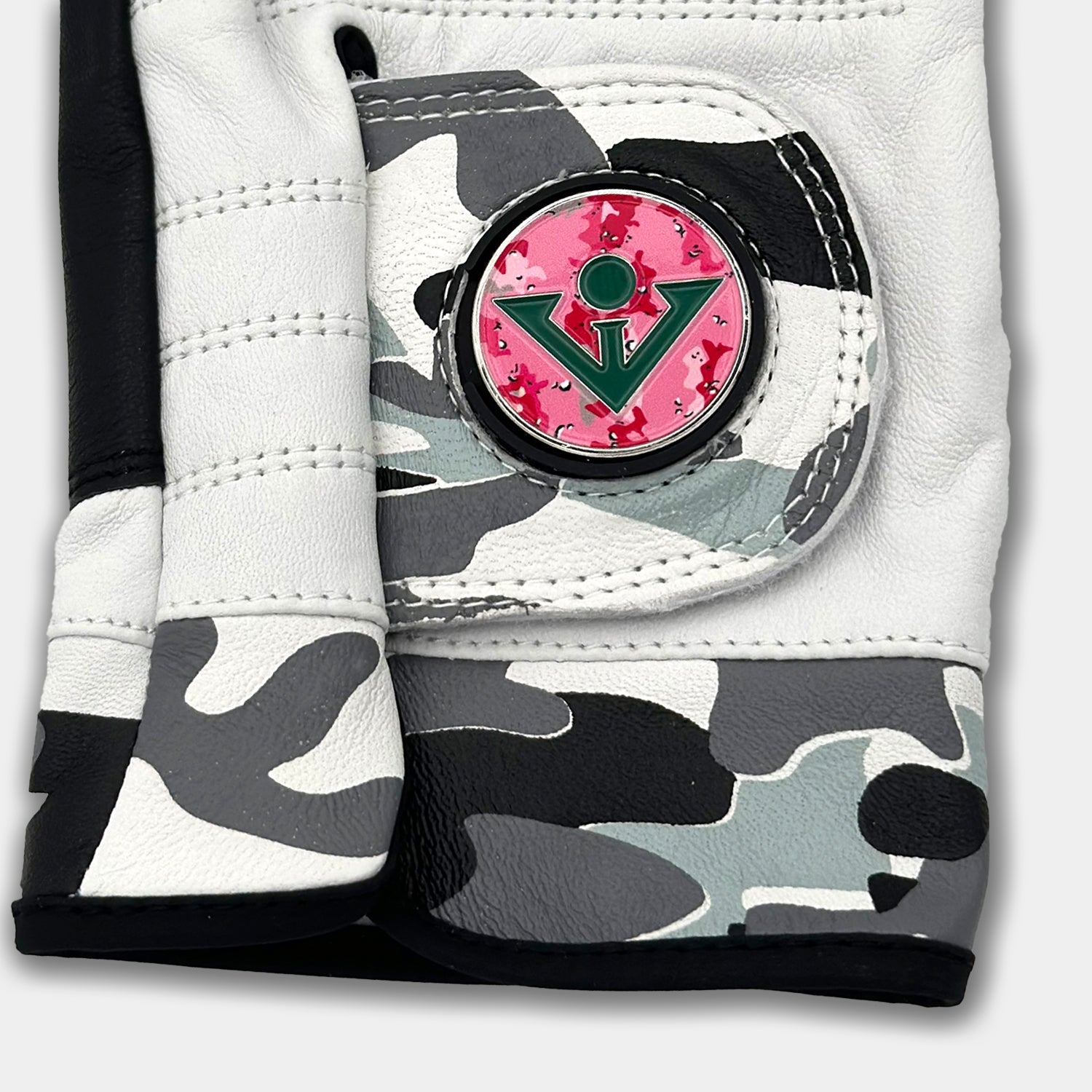 Close up of VivanTee women's gowanus ghost ghost golf glove with a pink camo golf ball marker. 