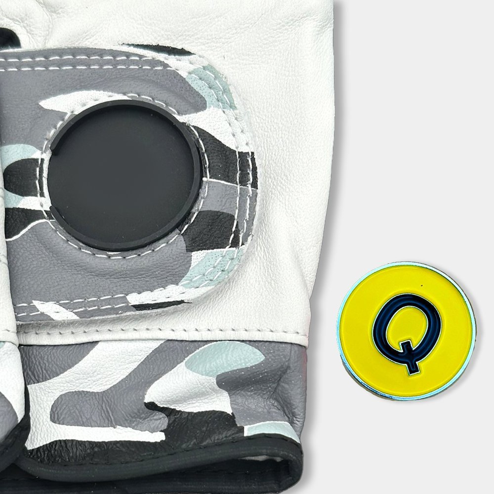 Camo golf glove with on a white background with magnetic ball marker out of the cavity.