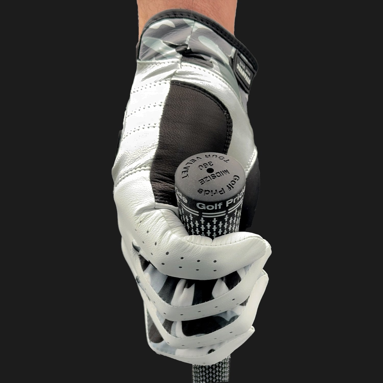 Camo golf glove with lycra inserts holding a golf club on a black background.