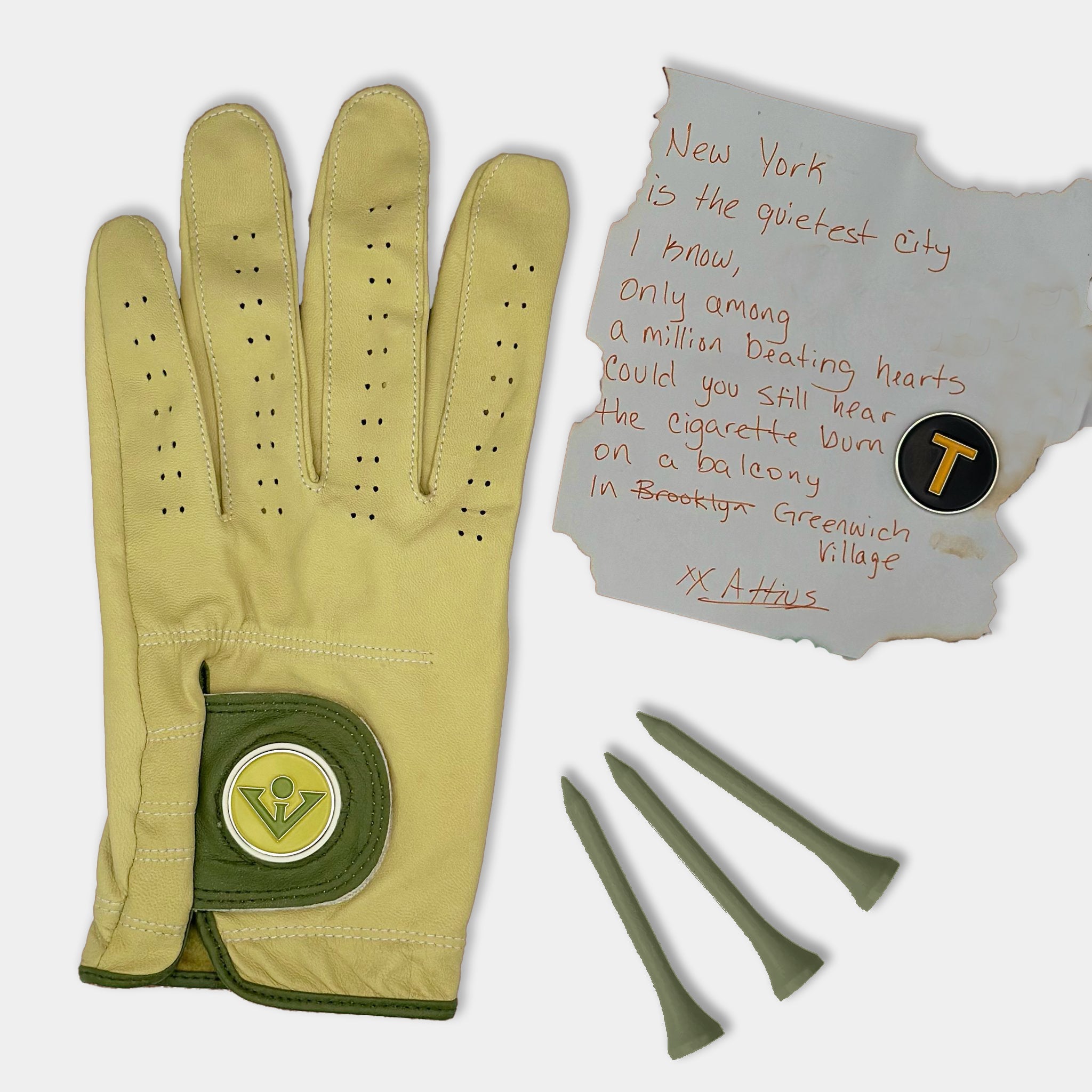 Yellow and Green golf glove with ball markers surrounded by earthy tones, wood, and a poem to represent Greenwich Village's Bohemian Style.Yellow and Green golf glove with ball markers surrounded by earthy tones, wood, and a poem to represent Greenwich Village's Bohemian Style.