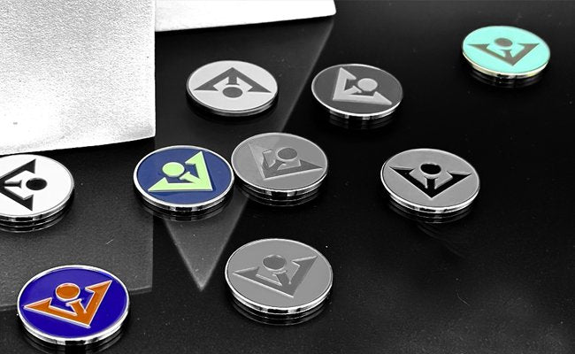 Assortment of VivanTee magnetic golf ball markers crafted for our magnetic golf gloves, prominently displaying the blue ones with others faded in black and white