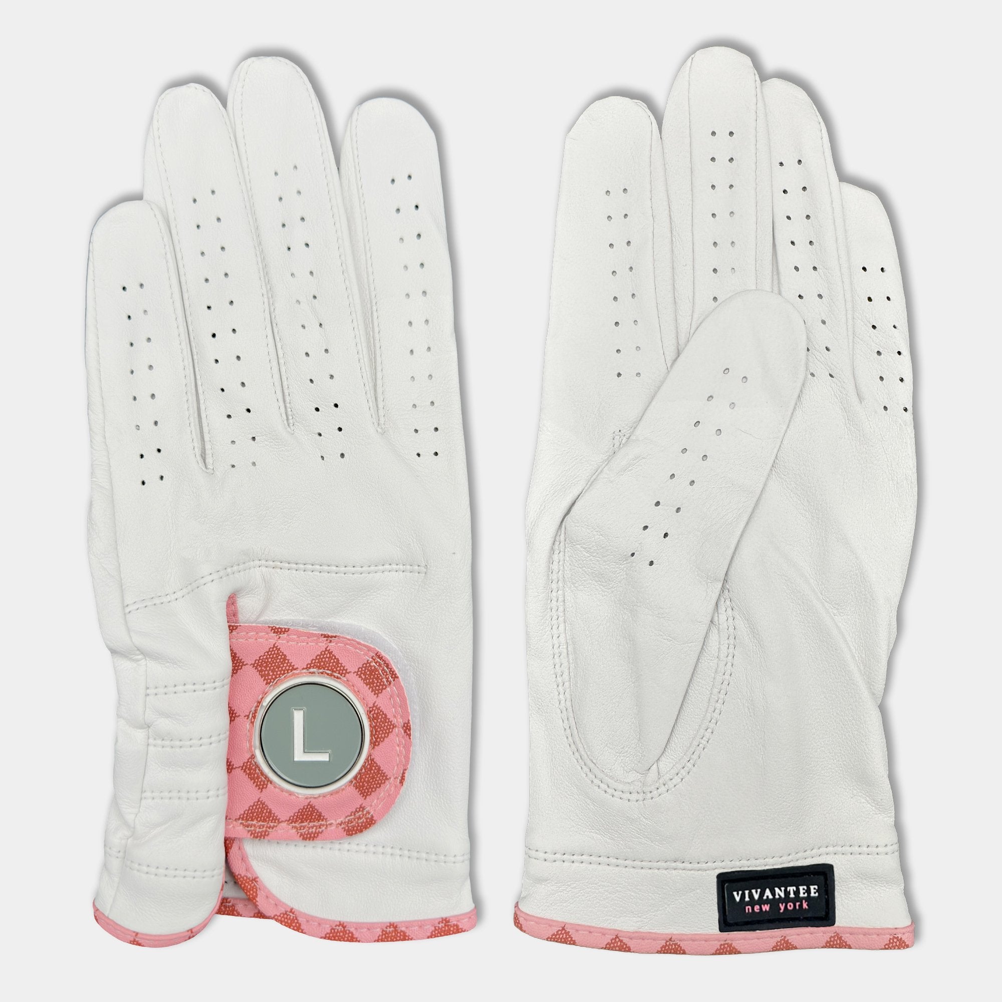 White and blush pink designer golf glove with a black backdrop to show case the unique colors and patterns.