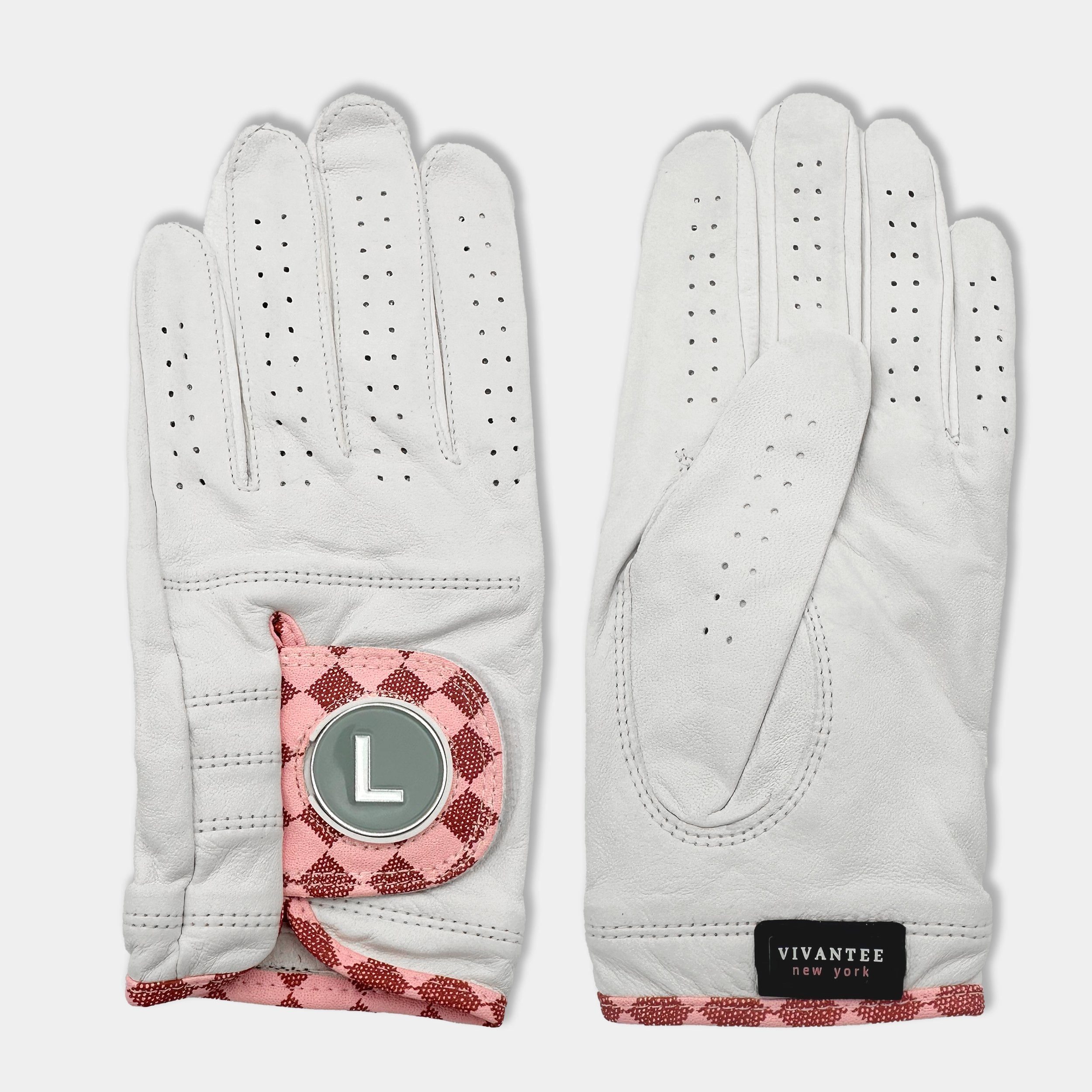 White and blush pink designer golf glove with a black backdrop to show case the unique colors and patterns.