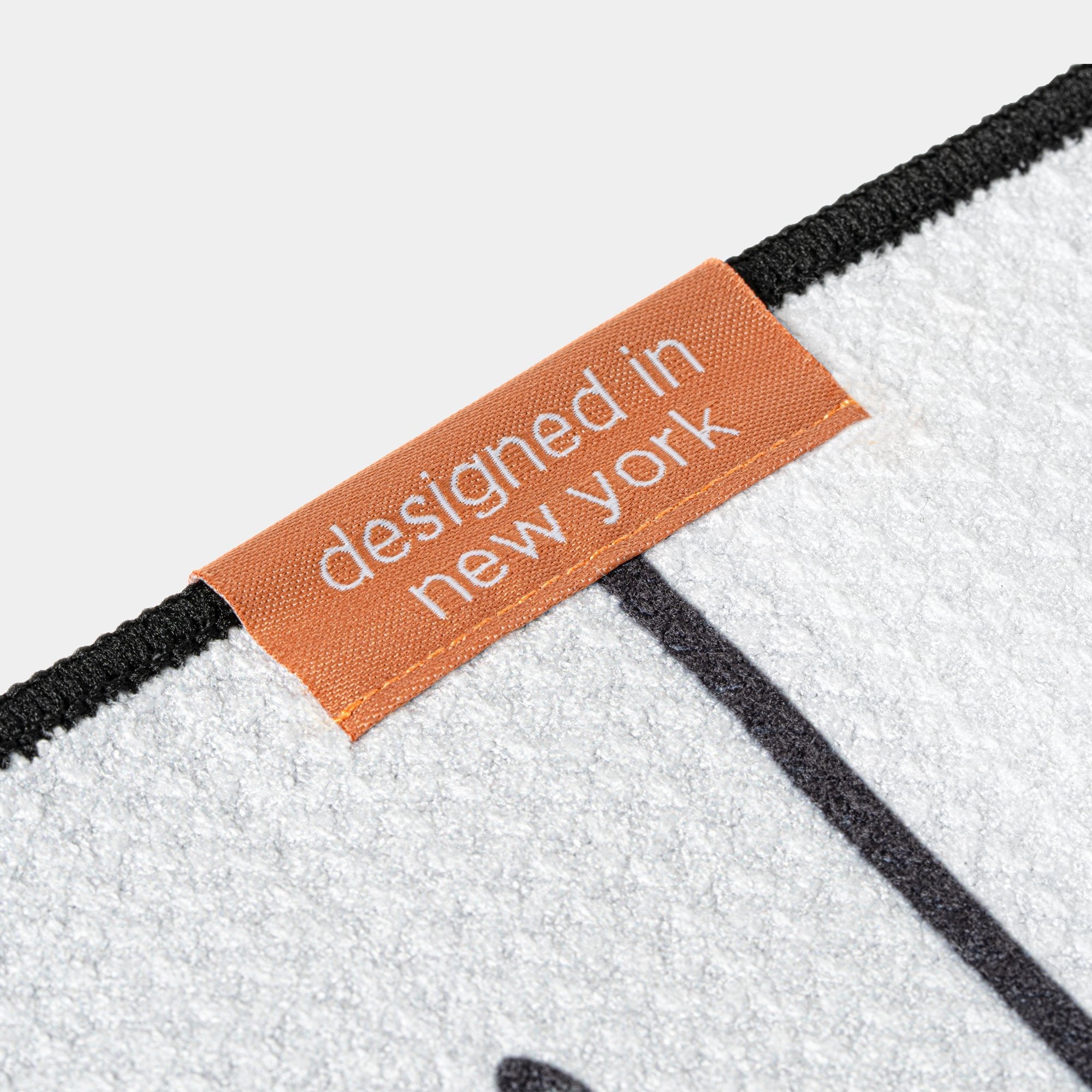Close up golf towel label with "designed in New York" by VivanTee Golf.