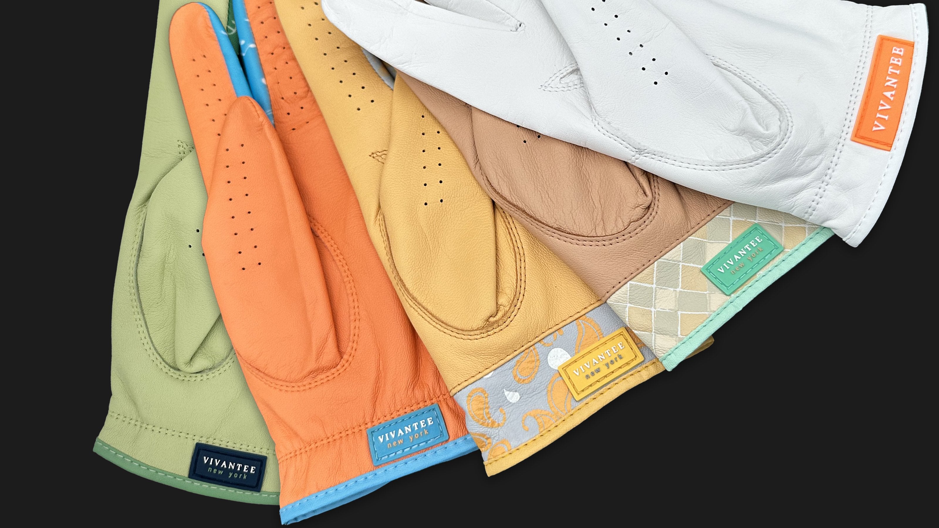 A variety of colored golf gloves by VivanTee Golf  showing their tag in different colors reading "VivanTee, New York".