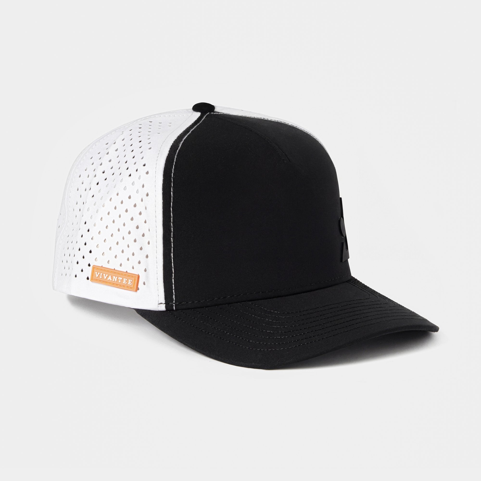 Two-tone golf cap with a black structured front and curved bill, and white mesh sides with small perforations. A subtle black emblem decorates the front, and an orange tag reading “VIVANTEE” is sewn on the side. The interior view displays branded cross straps.
