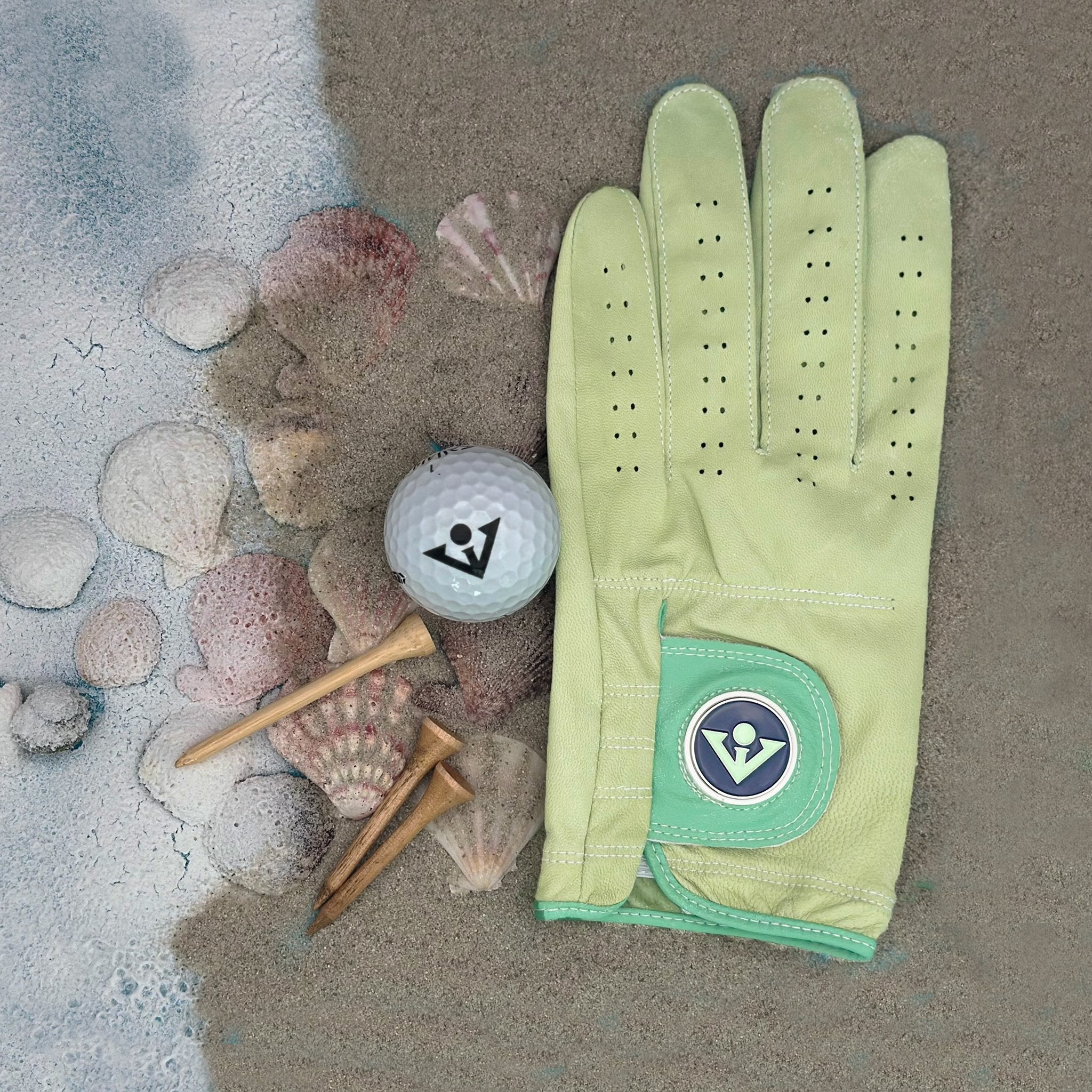 Seafoam Green designer golf glove with two levels of green on thumb and patch, in a black background to show the unique qualities and vibrant colors.