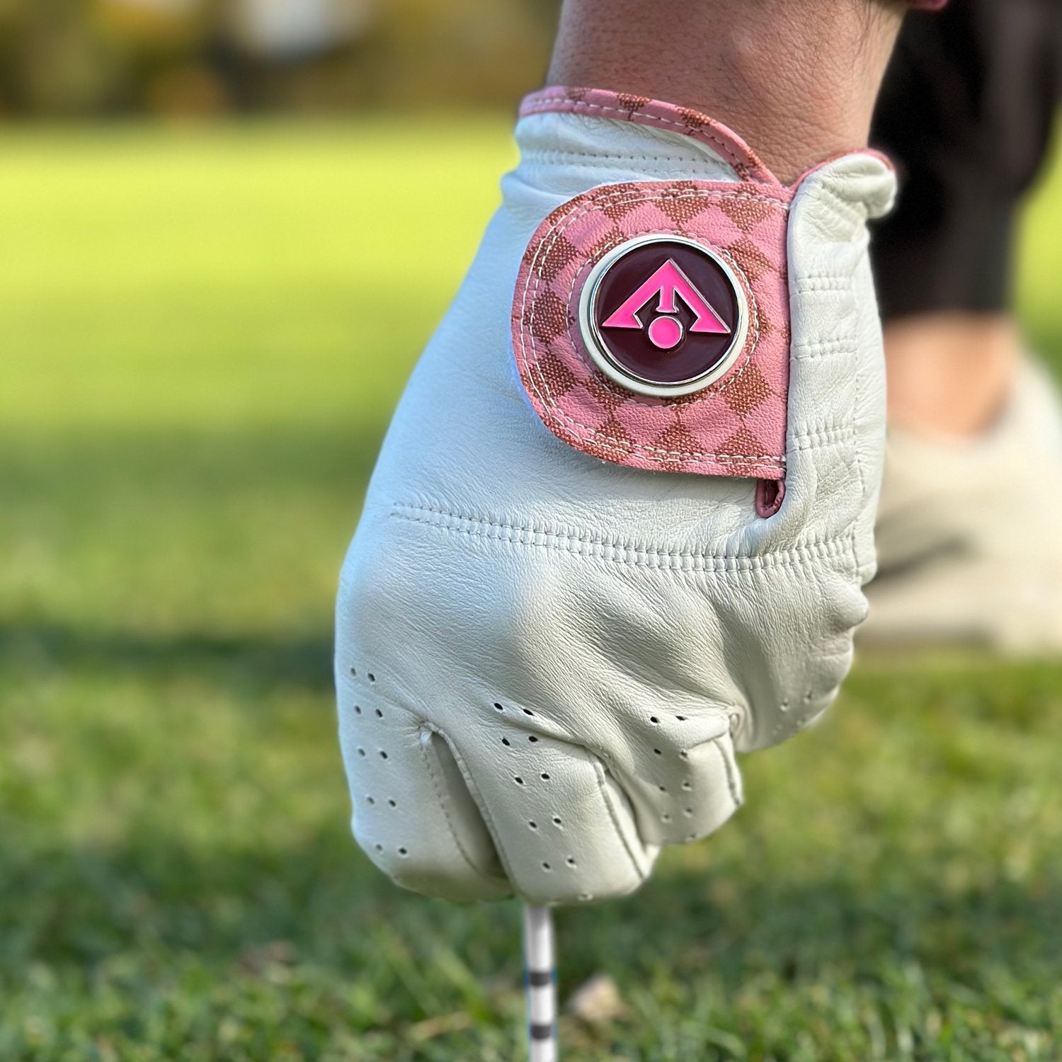 White and Pink checkered golf glove with a black and white background to show vibrance.