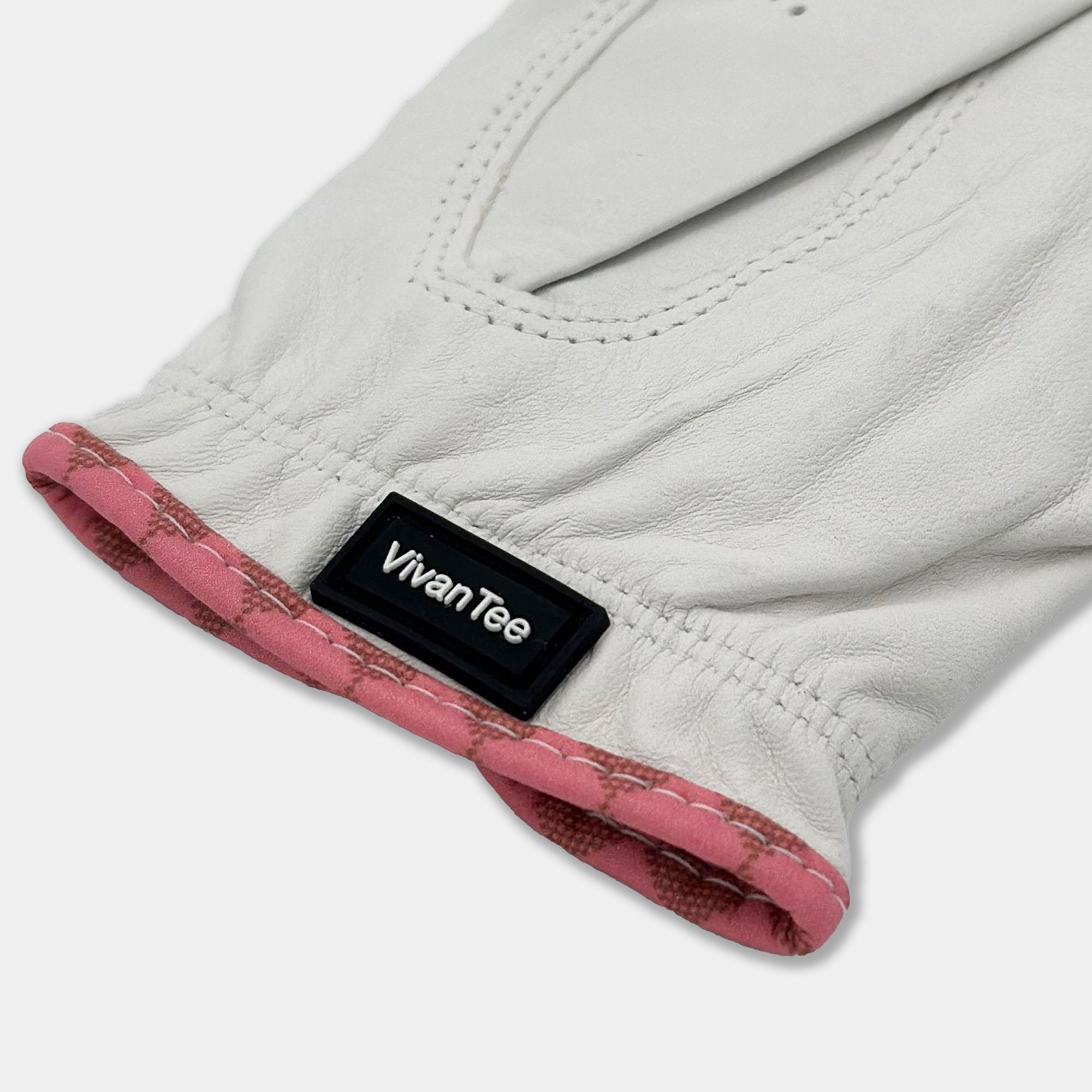 VivanTee pull tab close up on white and pink golf glove.