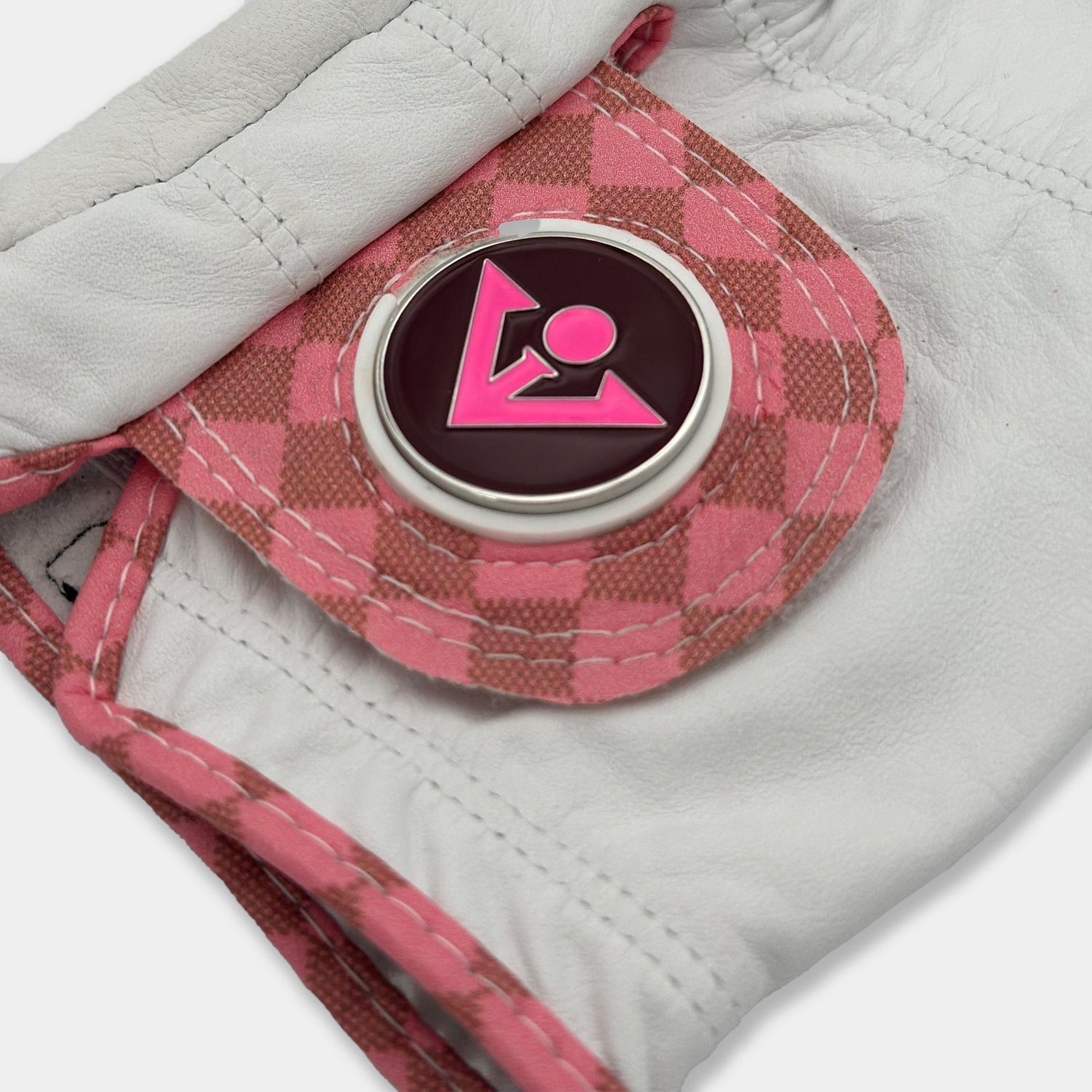 Close up of pink checkered golf glove with magnetic ball marker by VivanTee
